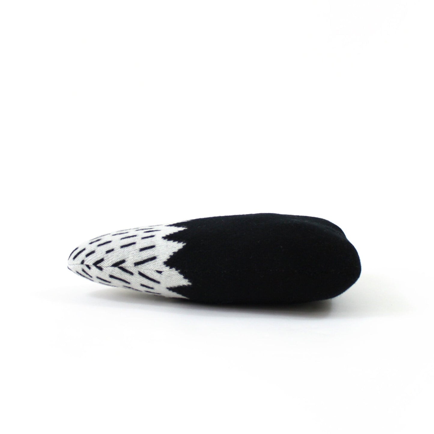 Black and white patterned mountain shaped pillow on a white background
