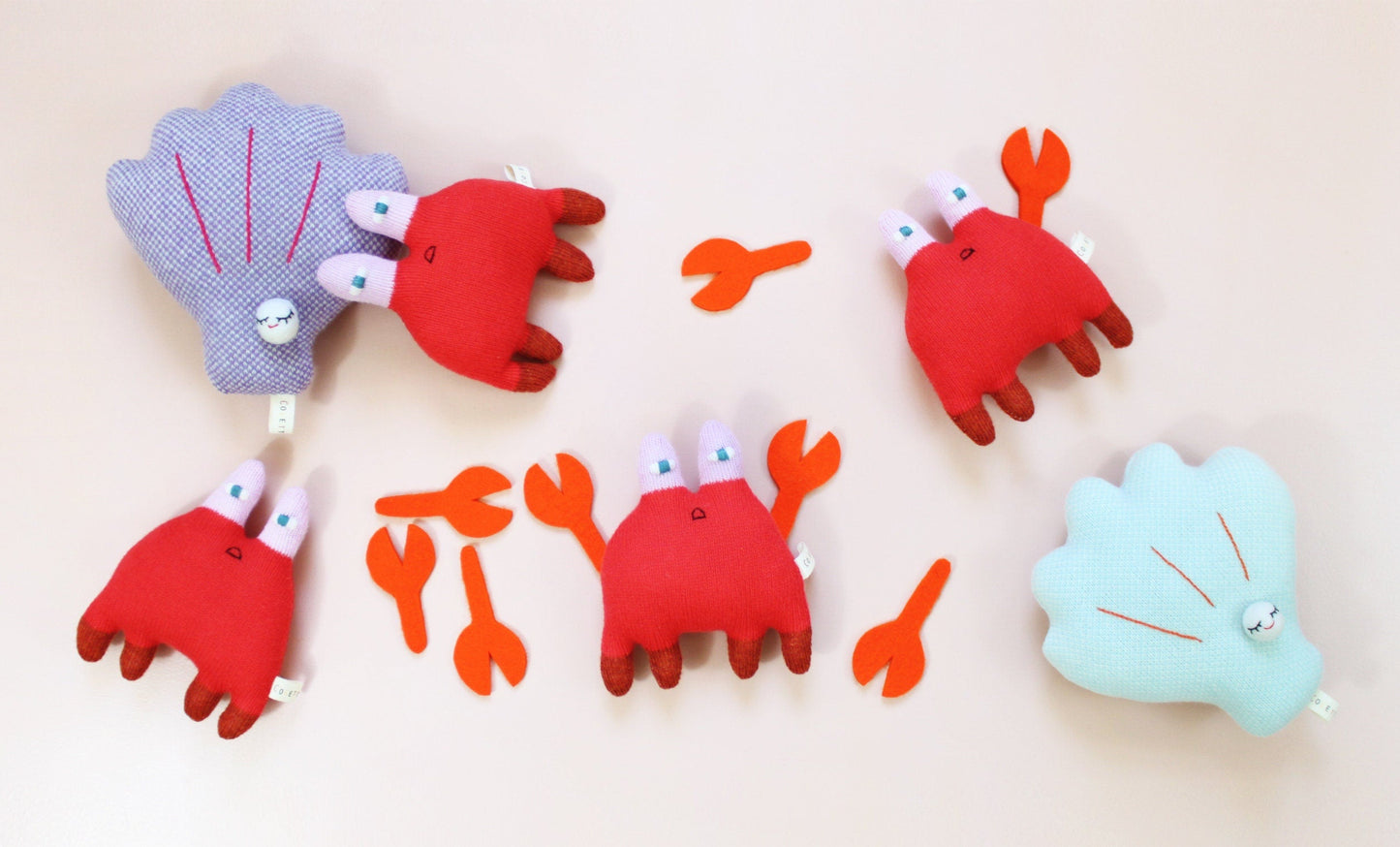 Set of colorful crab and shell toys on a beige background