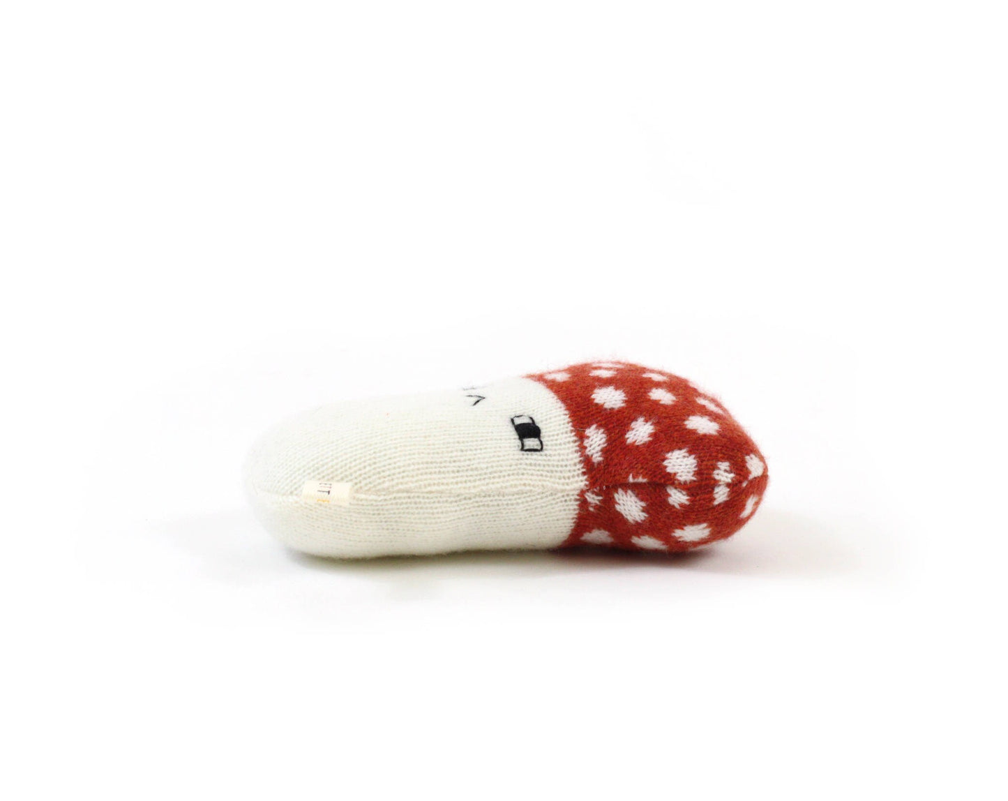 Red and white mushroom-shaped toy on a white background