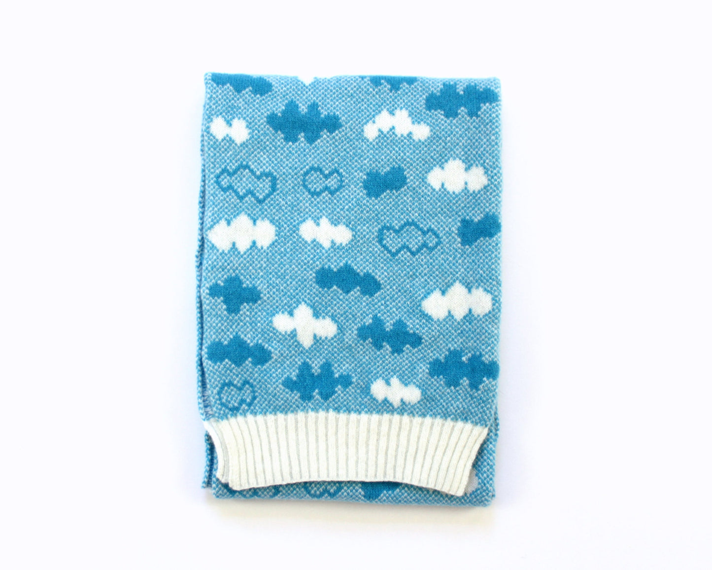 Blue knitted lambswool scarf with cloud pattern on a white background