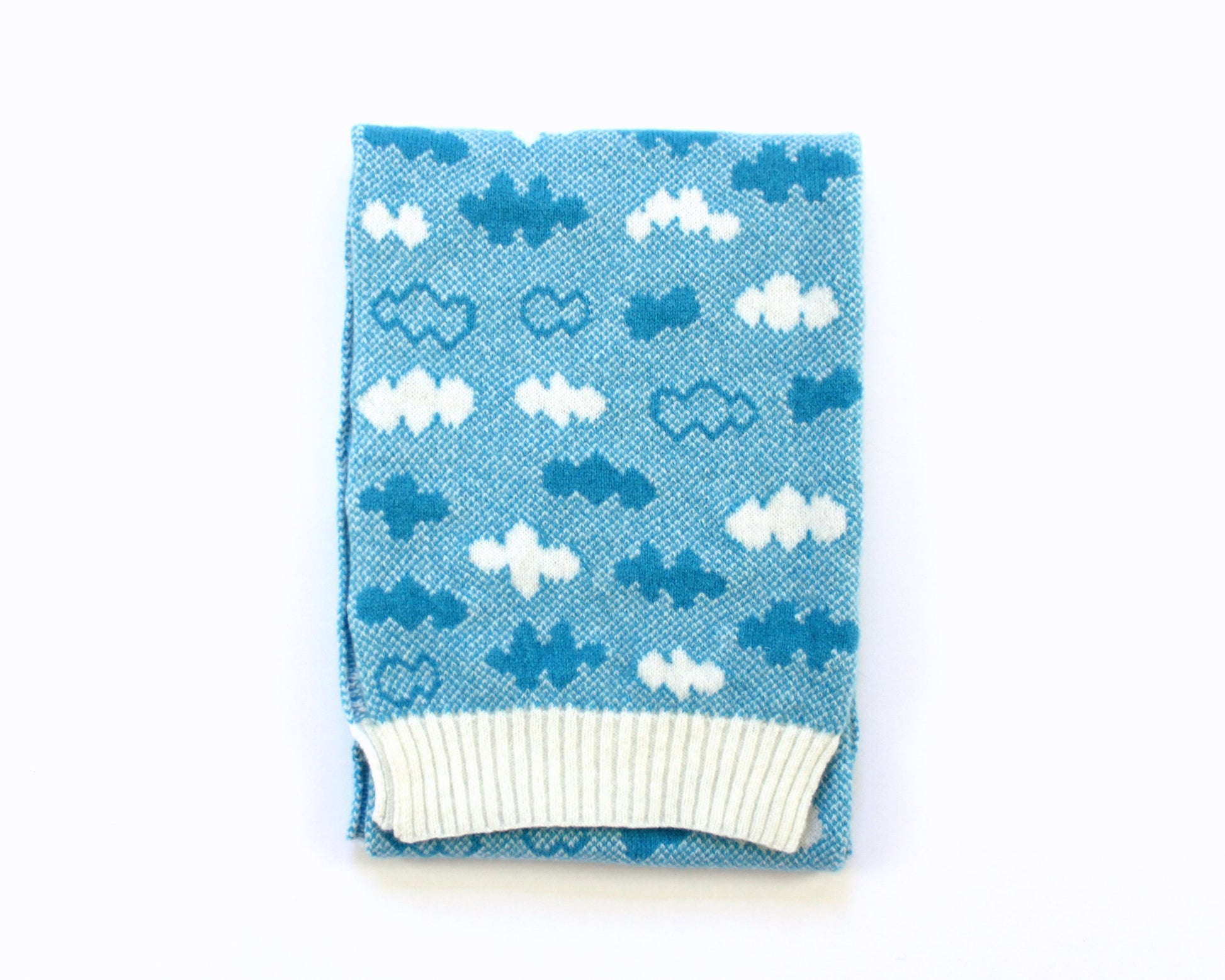 Blue knitted lambswool scarf with cloud pattern on a white background