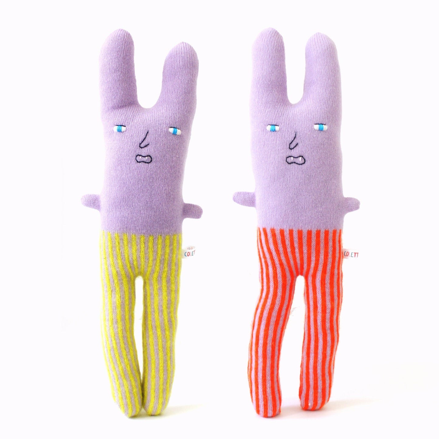 Two lambswool knitted plush toys shaped like a rabbit in striped pants on a white background