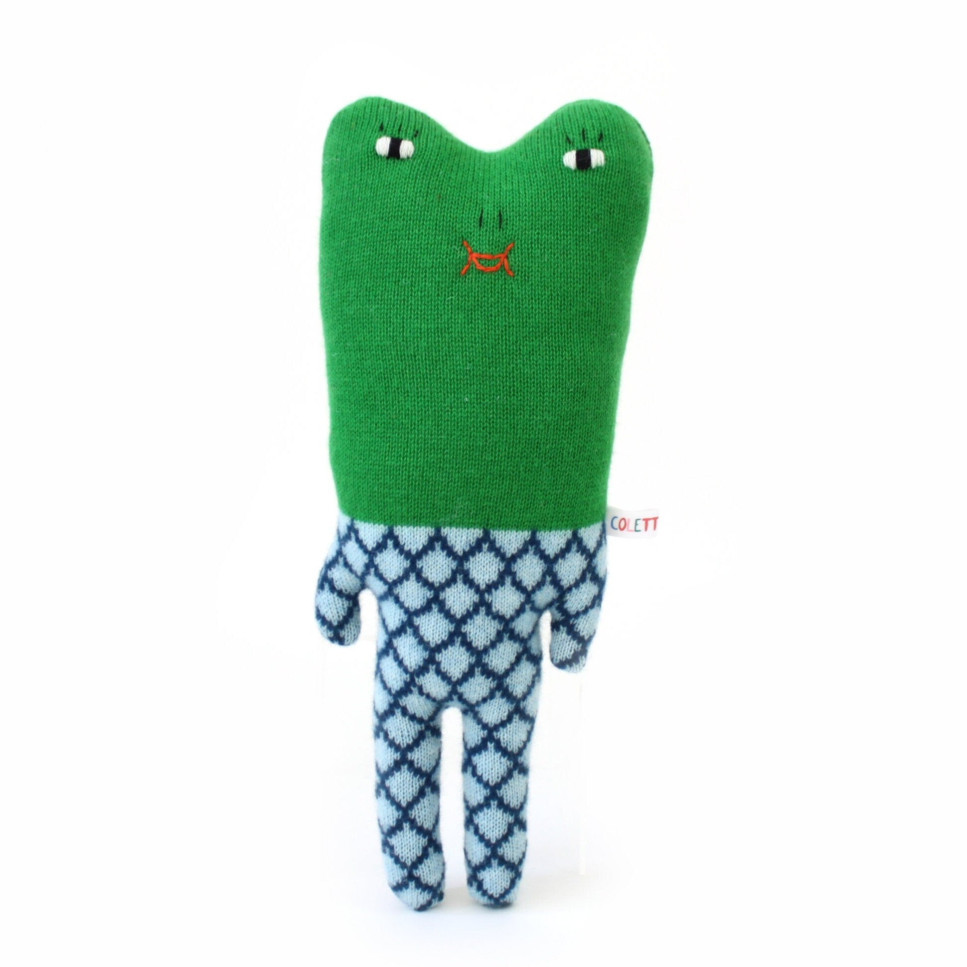 Green plush toy frog with a blue patterned body on a white background