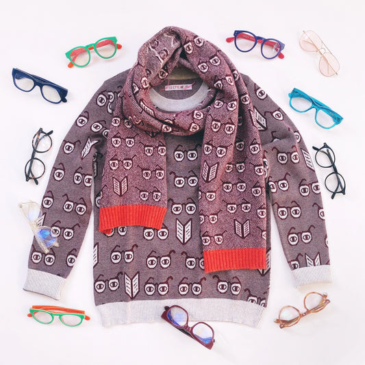 Patterned sweater with red accents surrounded by colorful spectacles eyeglasses on a white background