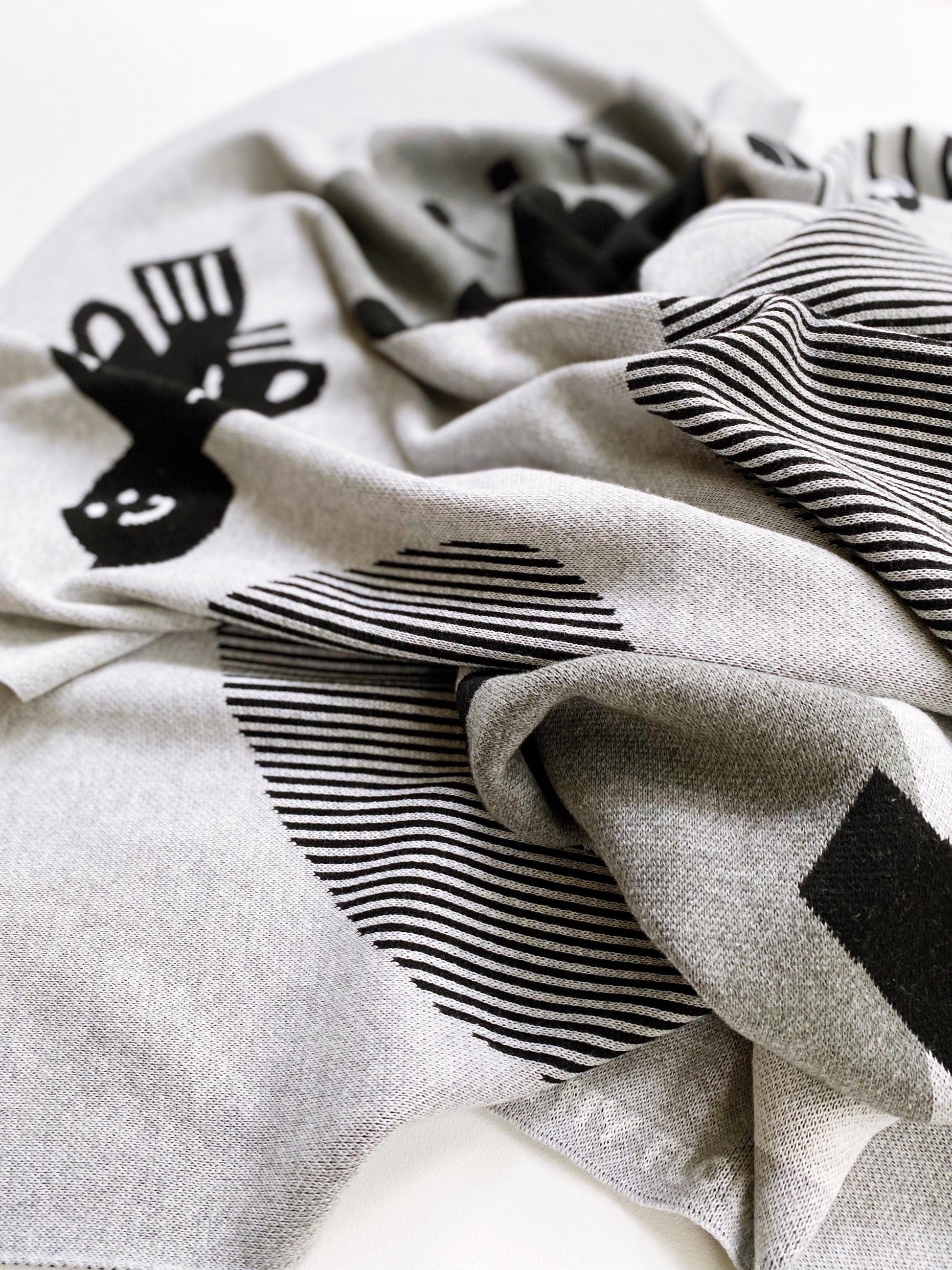 Gray knitted fabric with black cat and striped patterns