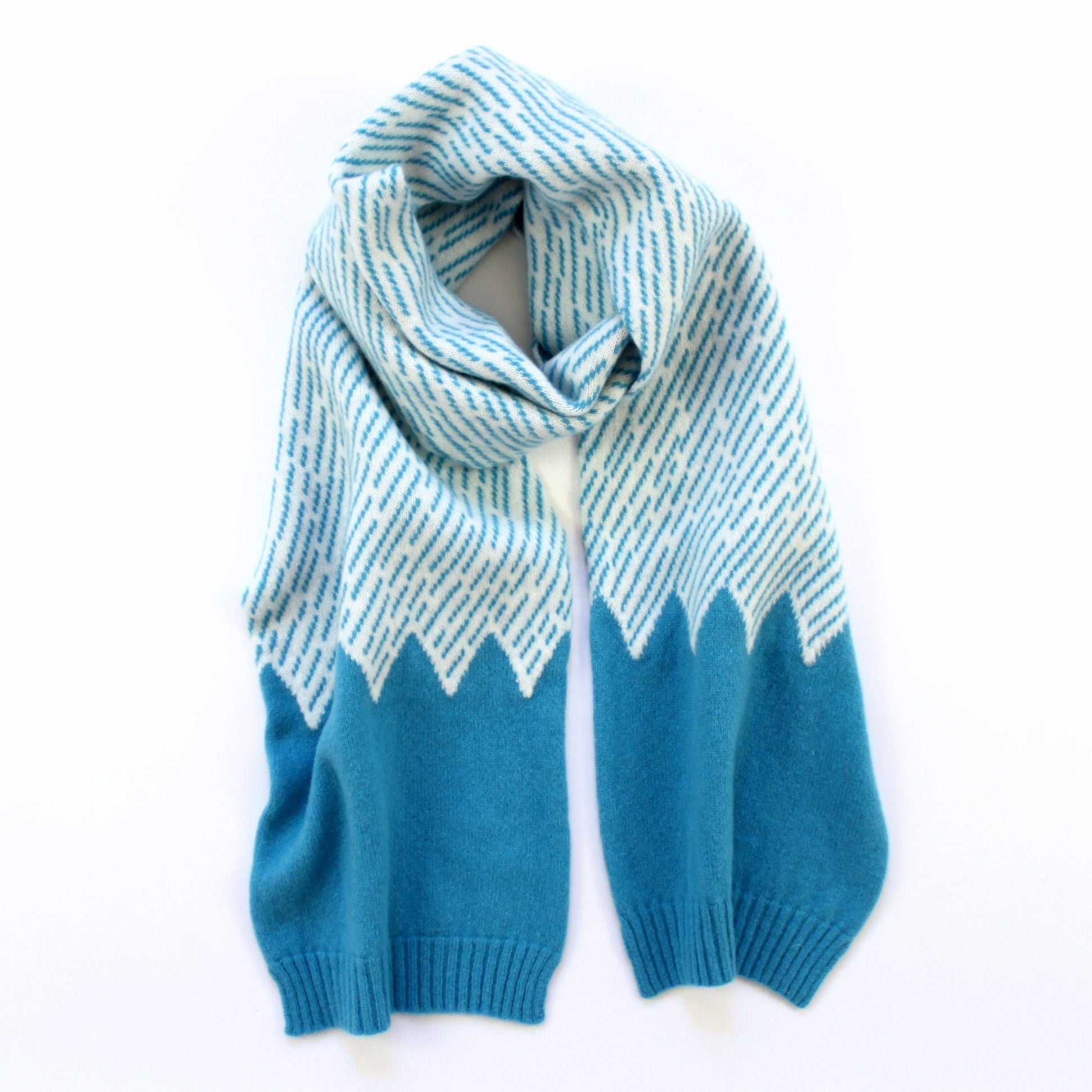 Blue and white striped scarf with mountain design on a white background