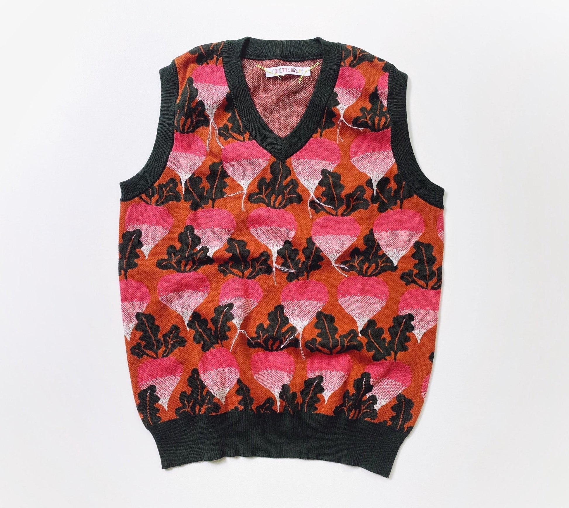 Sweater vest with beets radishes pattern on a white background