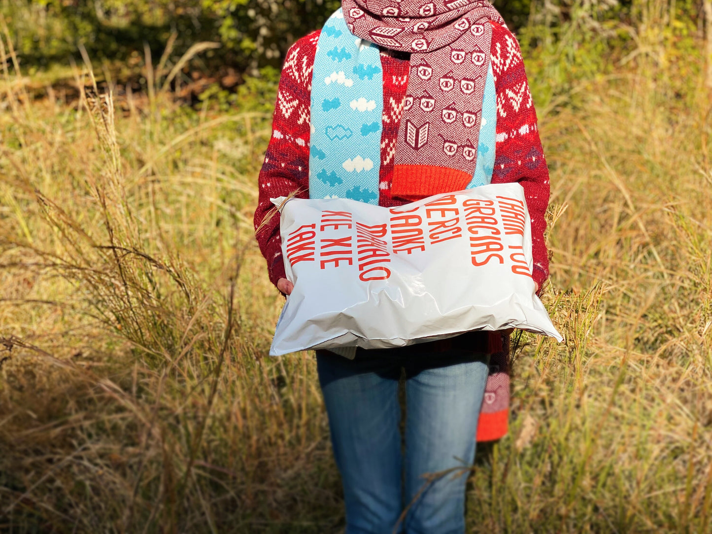 Person holding a large white bag with text in a field