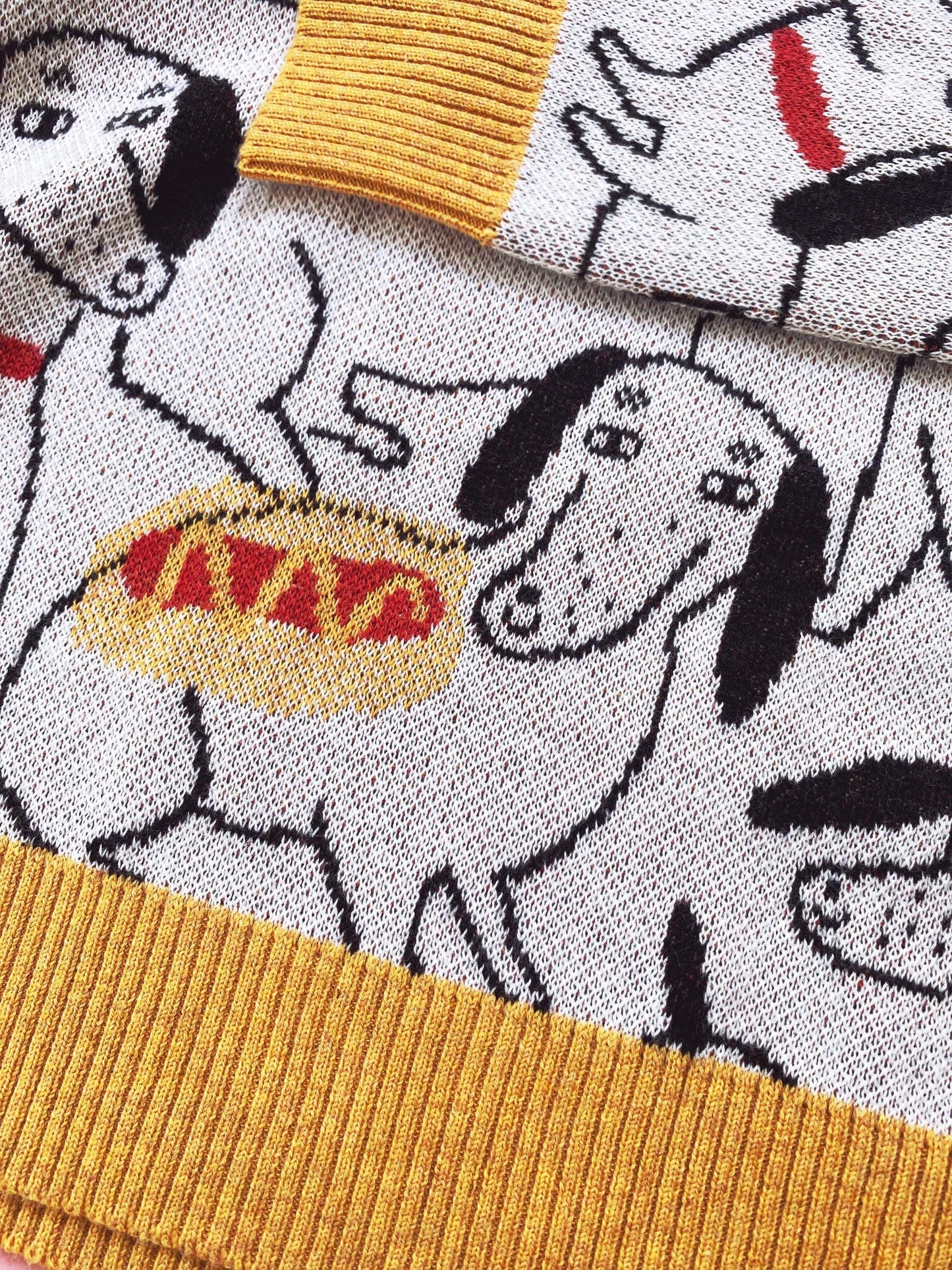 Sweater with cartoon sausage dog design and mustard yellow ribbed trim