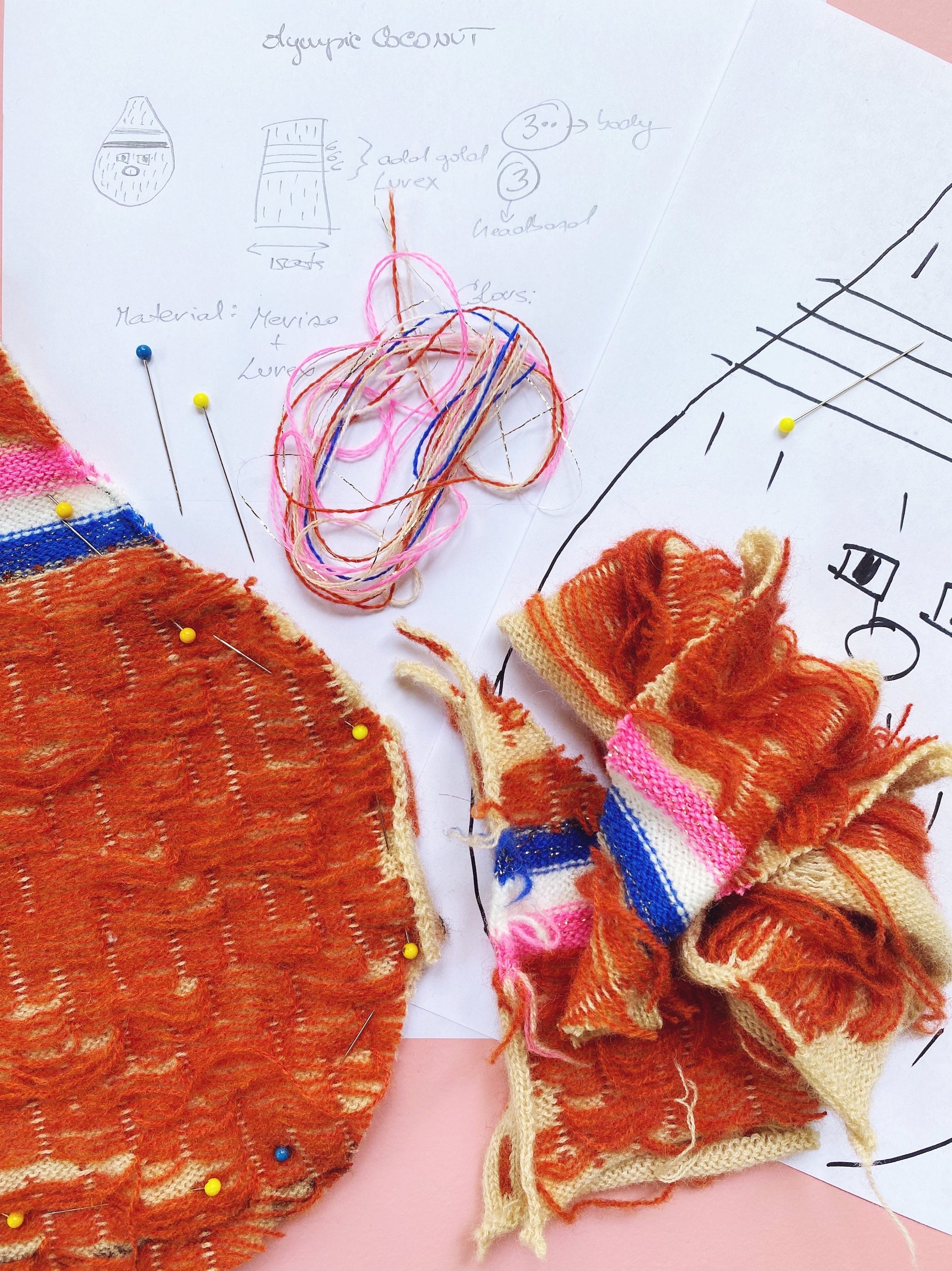 Embroidery work with colorful thread and fabric on a white surface with design patterns.