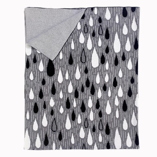 Grey knit blanket with black and white raindrop pattern