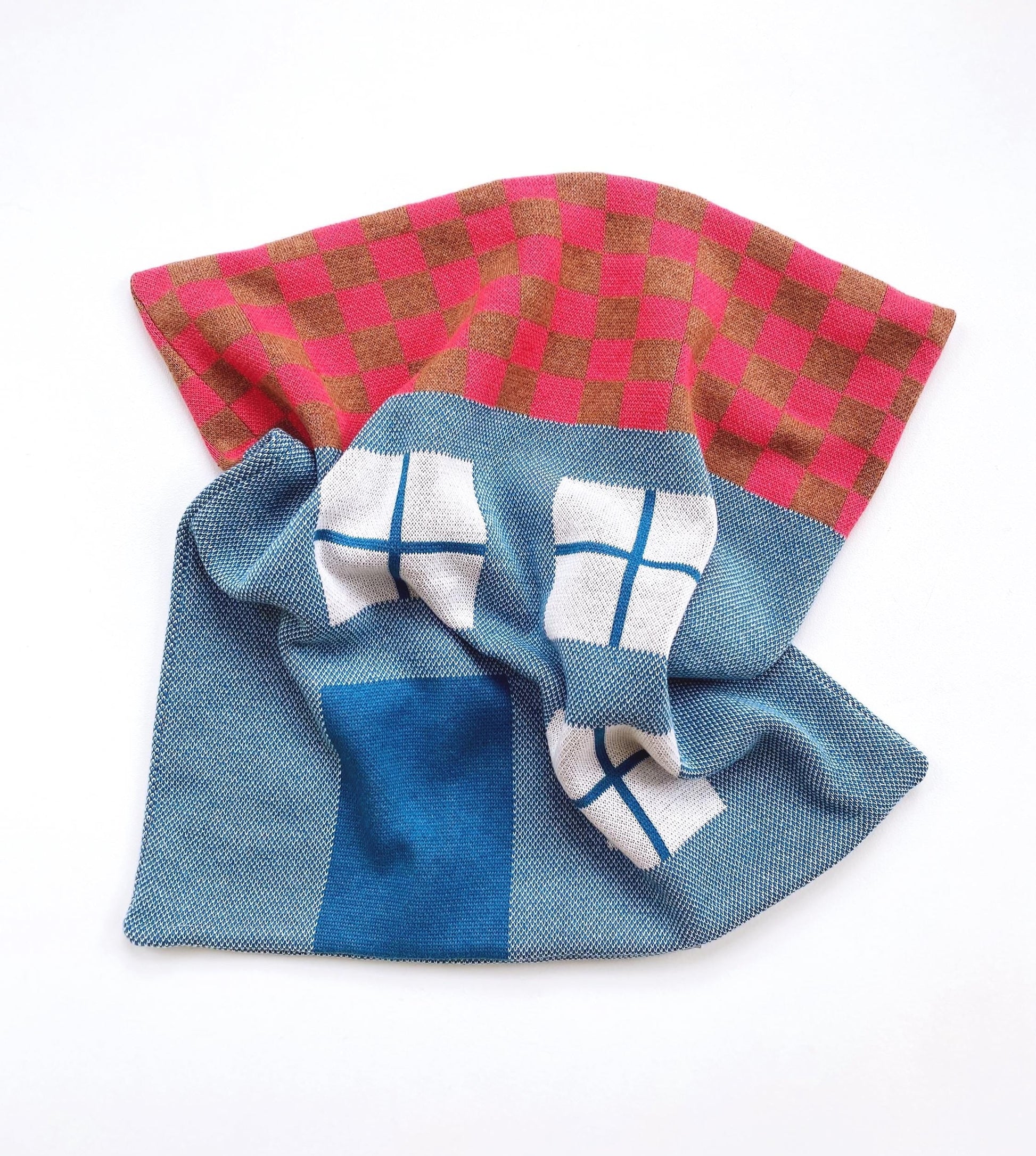 Decorative house shaped pillow on a white background