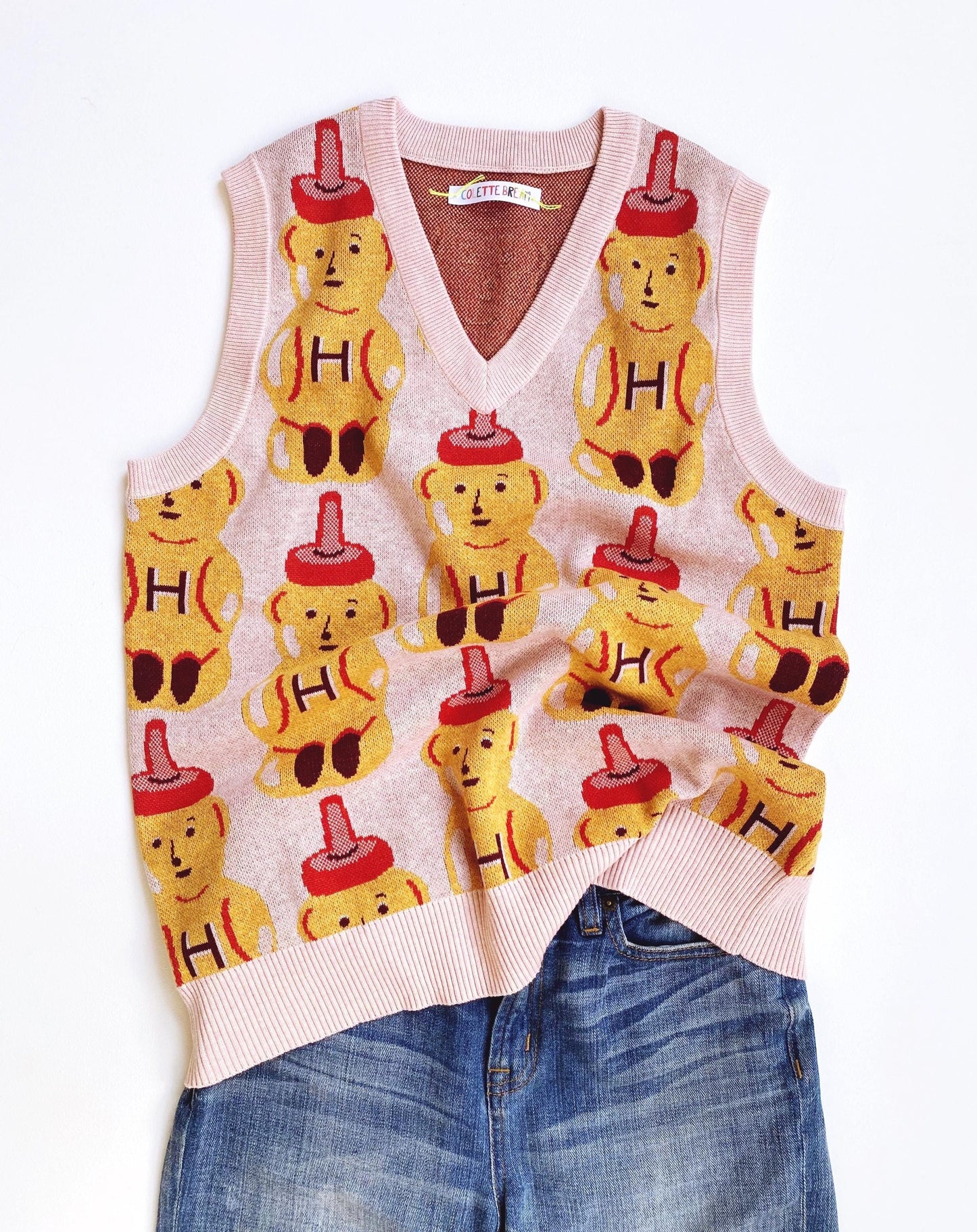 Sweater vest with honey bear pattern on a white background