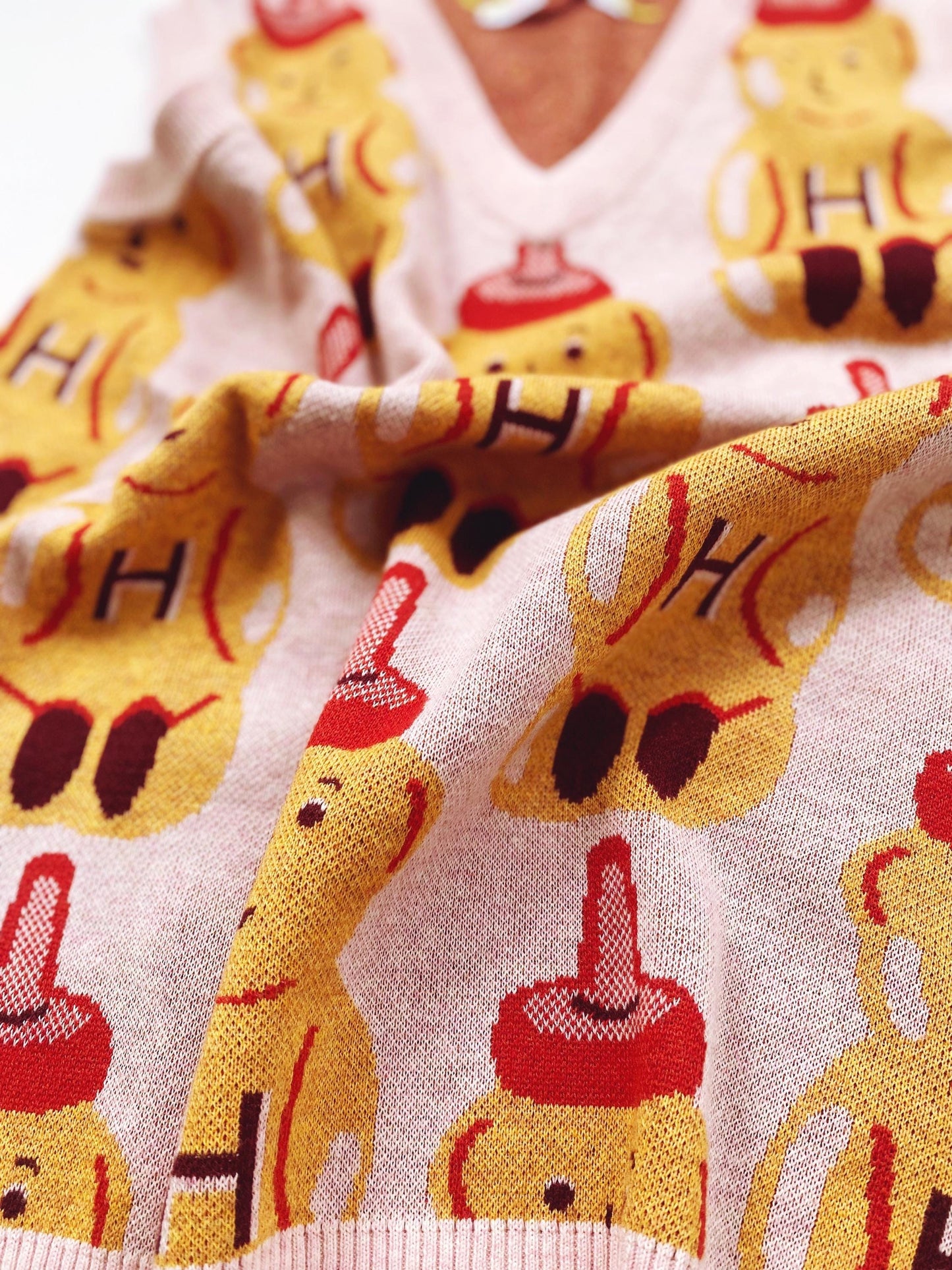 Close-up of a sweater with cartoon honey bear character pattern