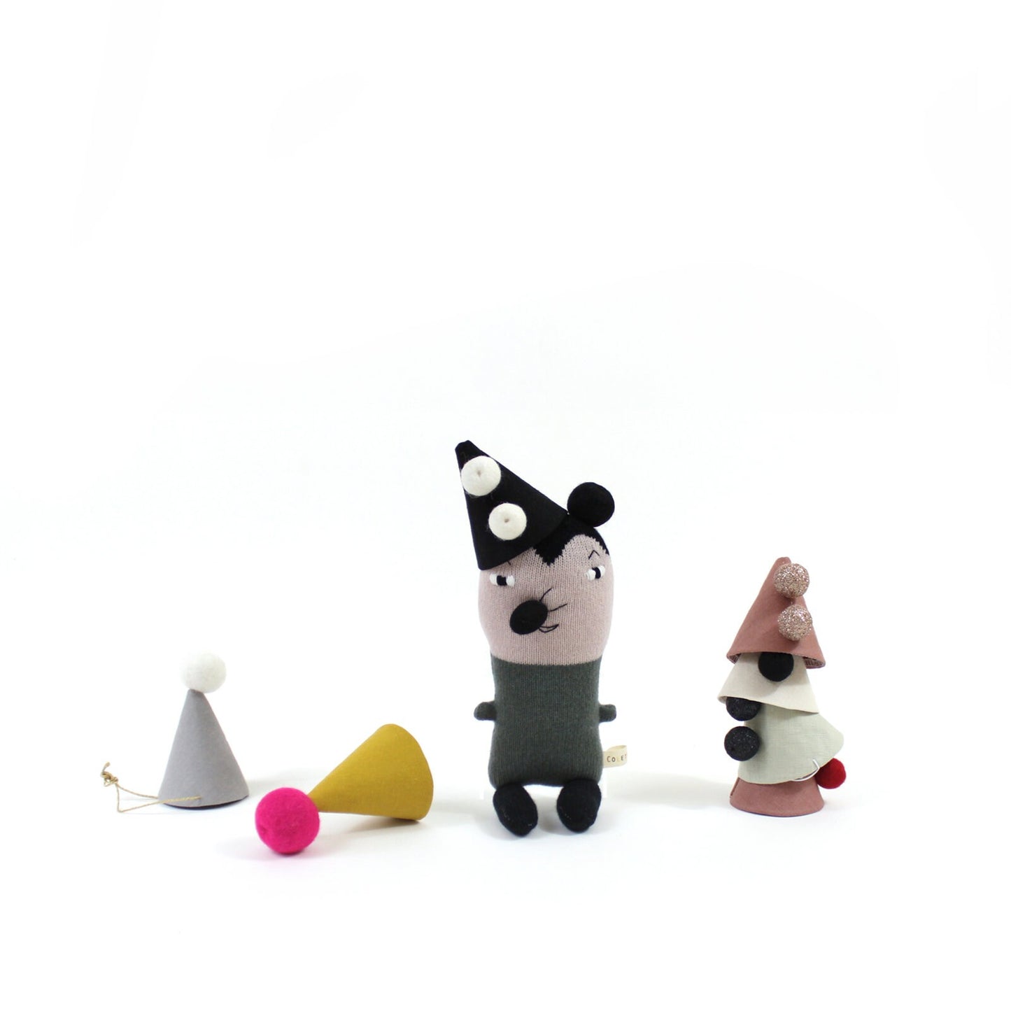 Knitted plush toy mouse with a black party hat and gray outfit, surrounded by colorful party hats on a white background