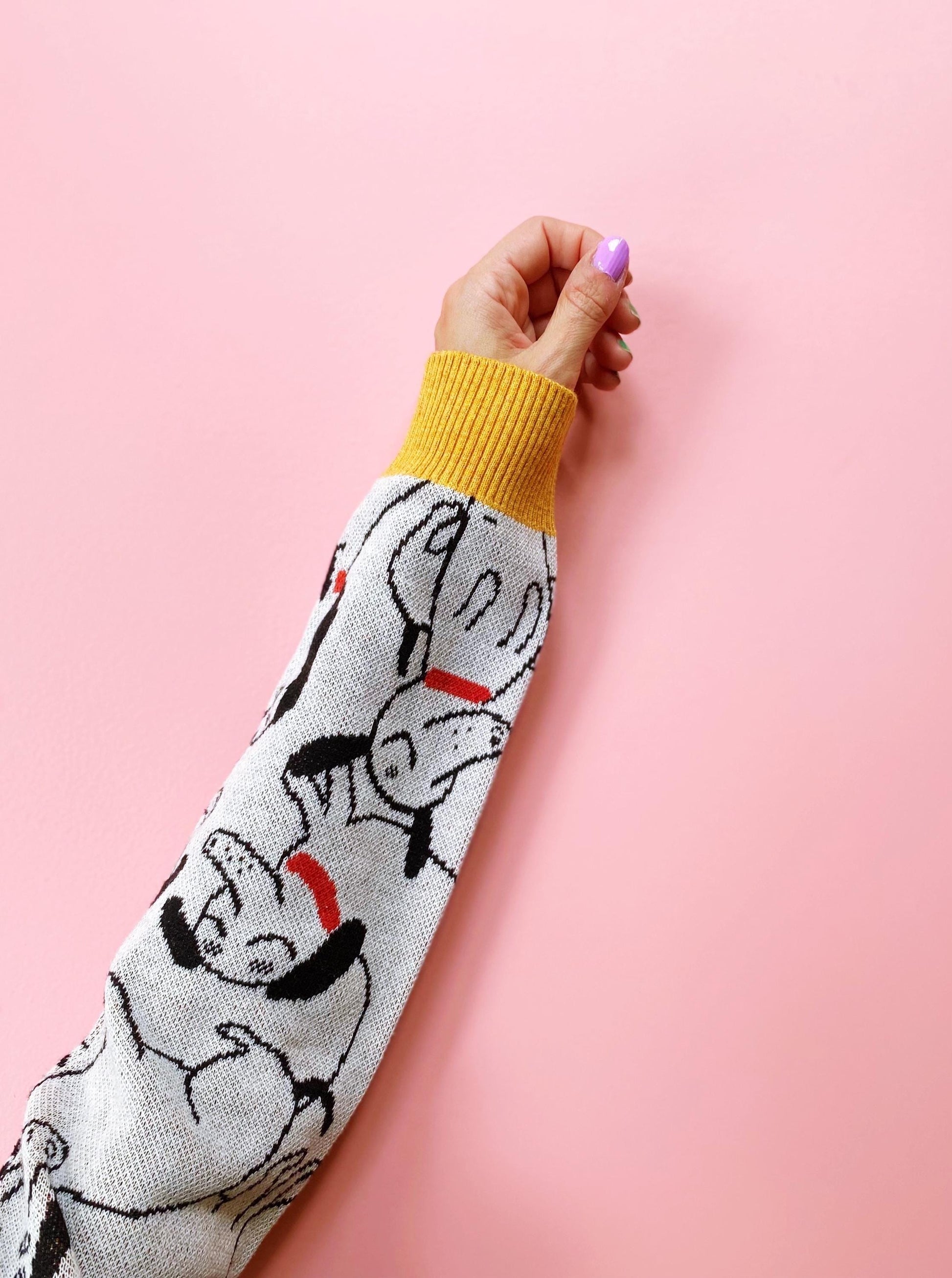 Sleeve with cartoon dachshund dog character design on a pink background