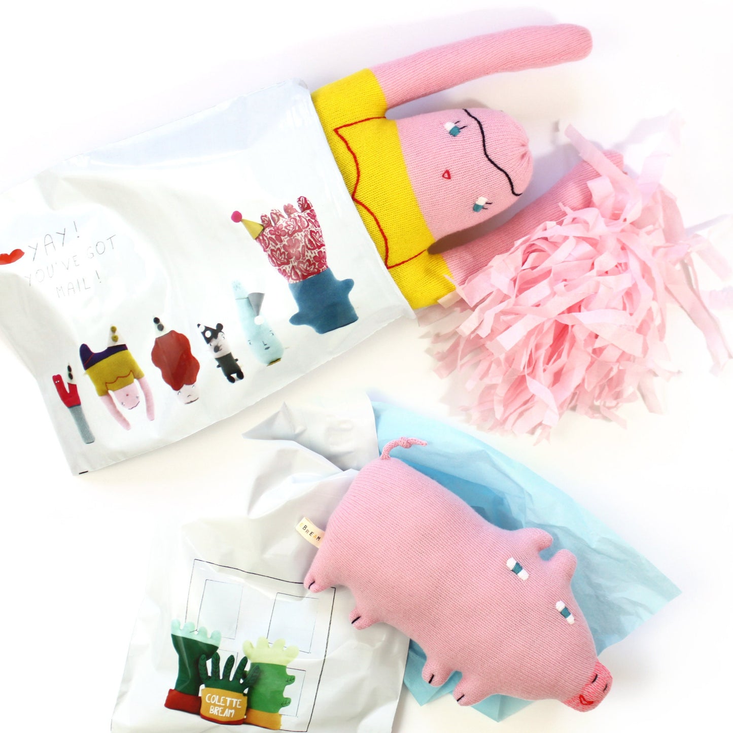 Knitted plush toys and decorative items on a white background