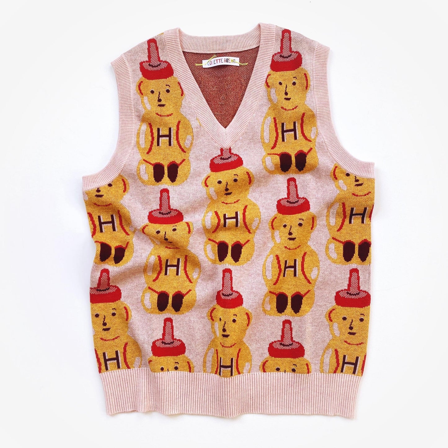 Sweater vest with a honey bear pattern on a white background