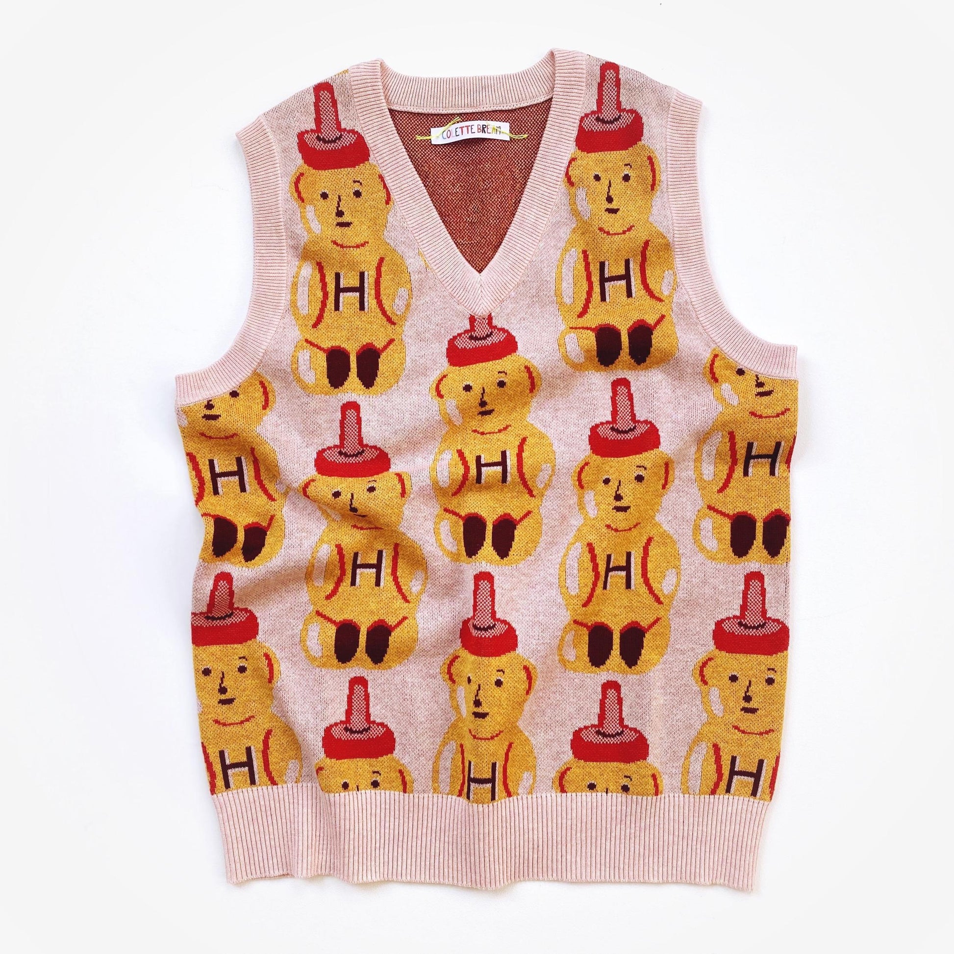 Sweater vest with a honey bear pattern on a white background