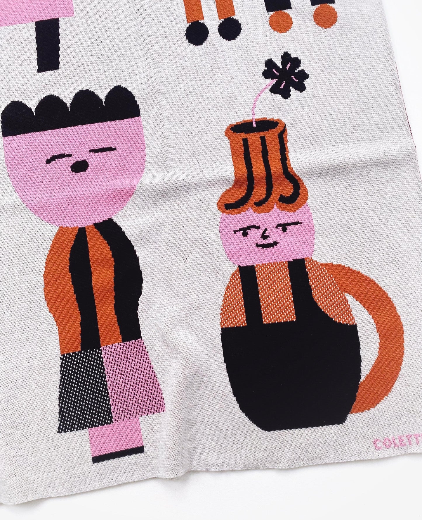 Knitted textile with cartoon-like characters on a light gray background