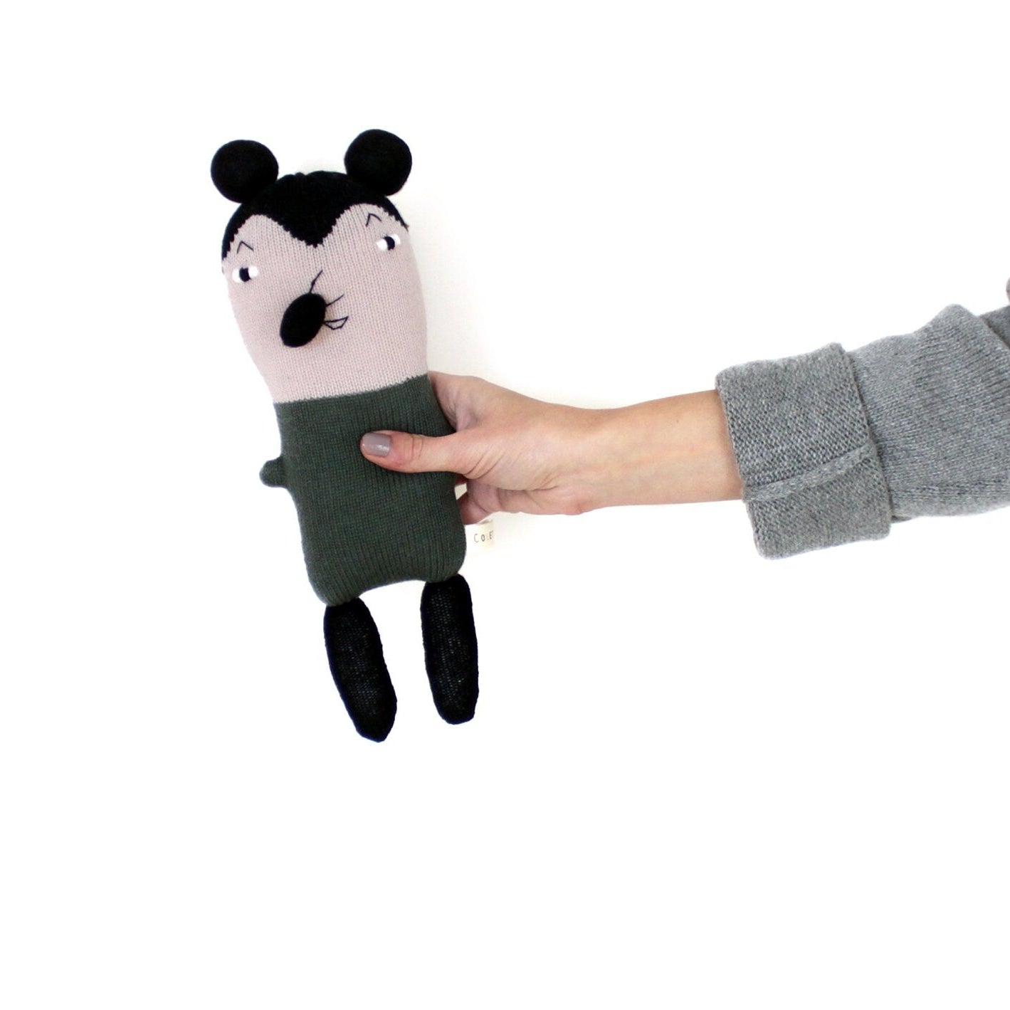 Hand holding a small plush toy mouse with a minimalist design on a white background