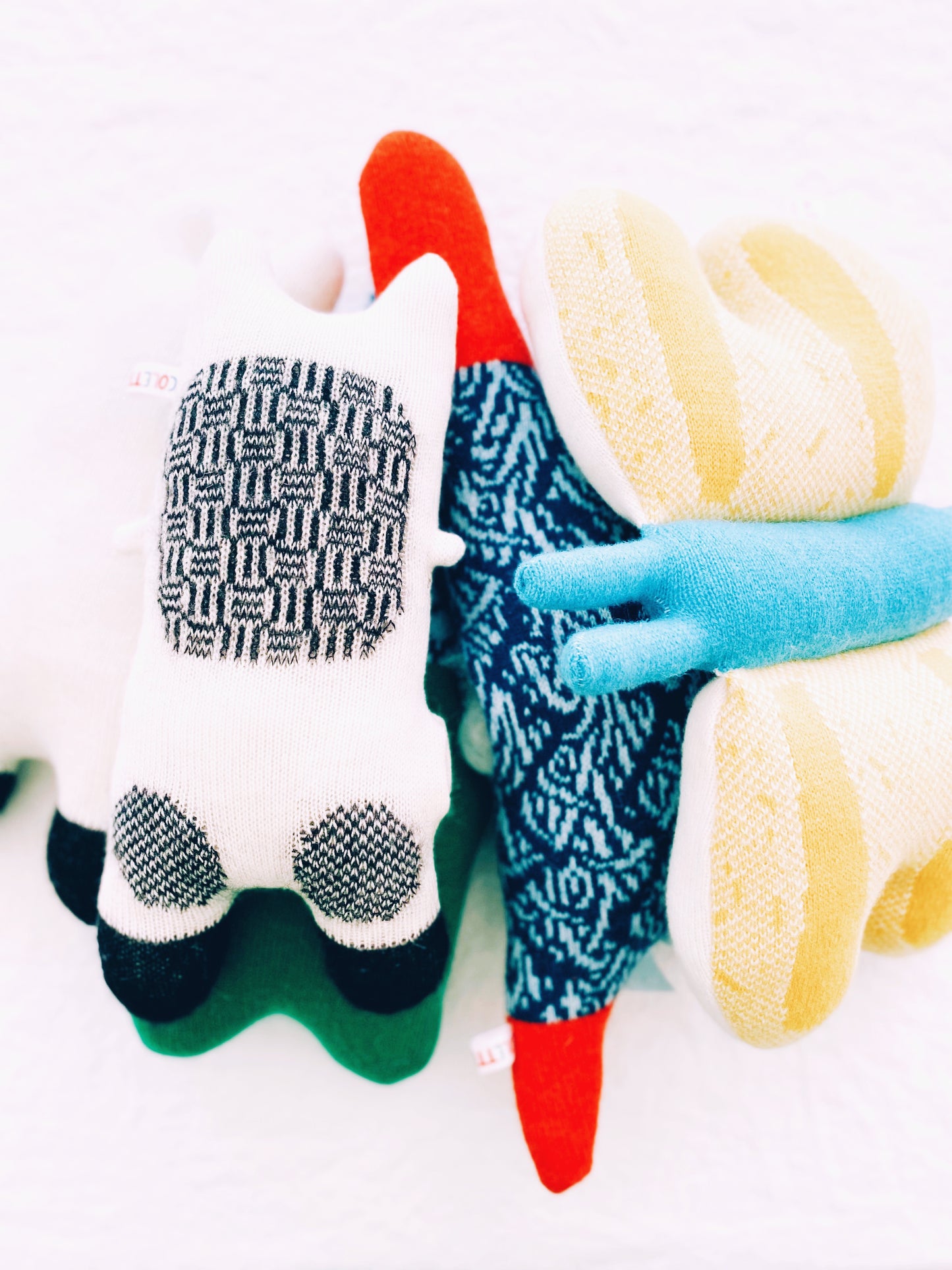 Colorful knitted animal toys on a white background