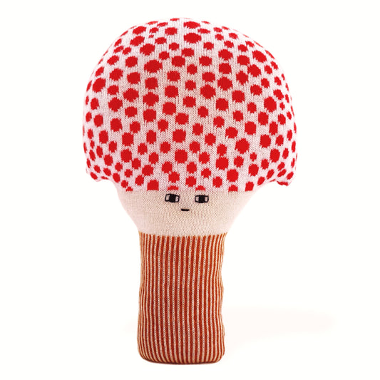 Knitted mushroom toy cushion with red polka dot cap and striped body on a white background