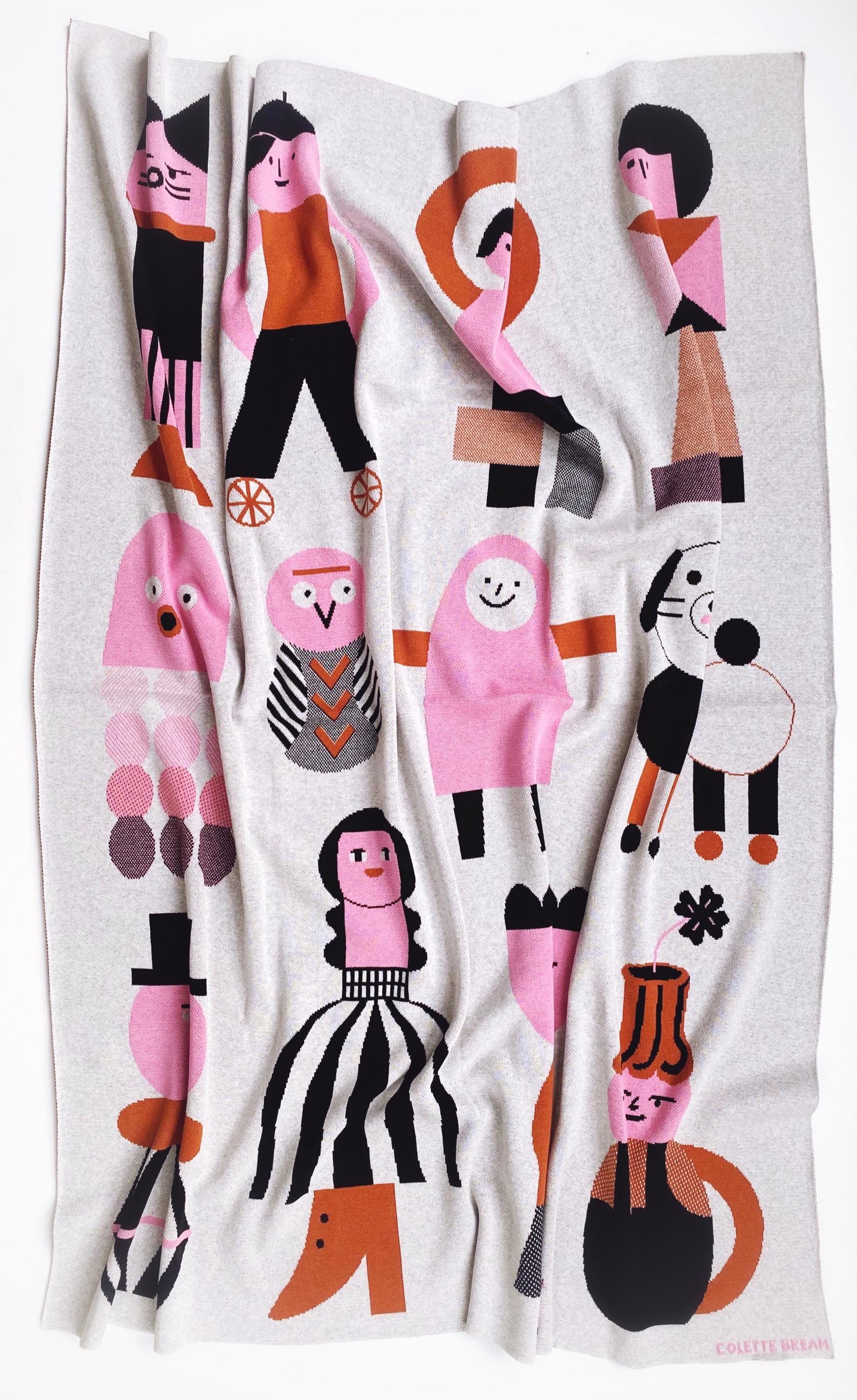 Decorative knit blanket with colorful abstract patterns on a white background