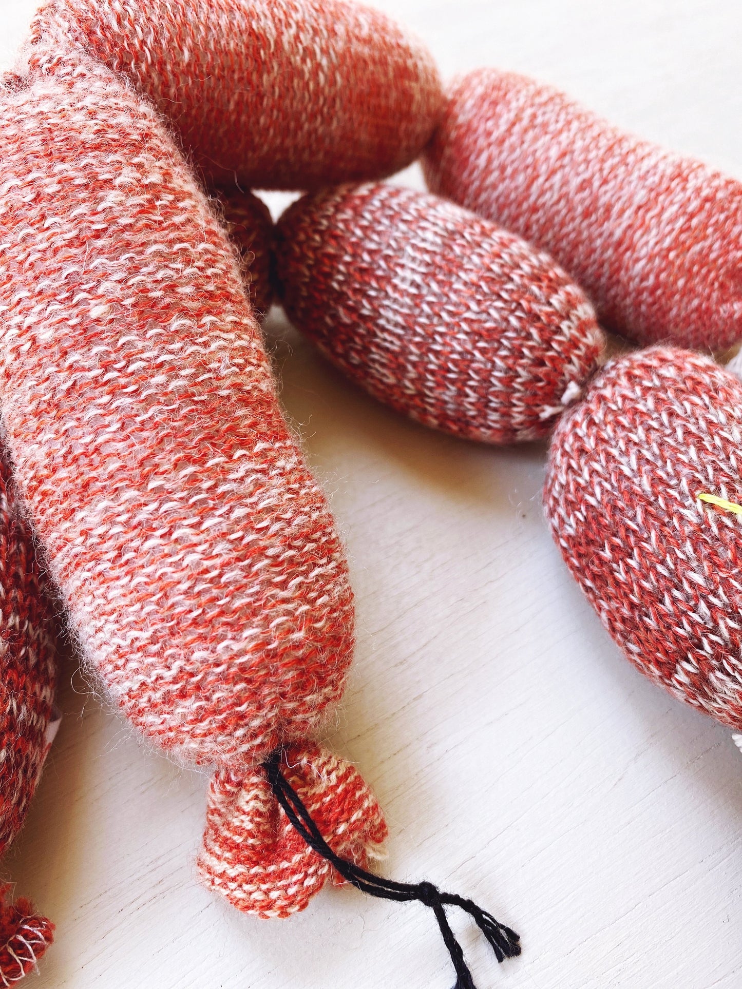 Knitted sausages on a light background