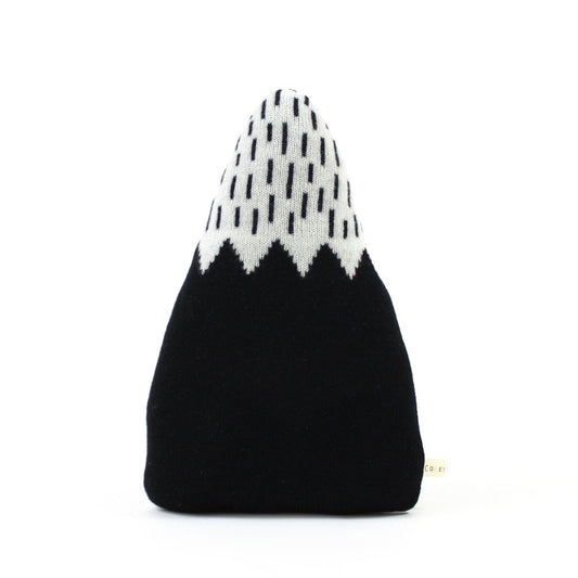 Black and white patterned mountain shaped pillow on a white background