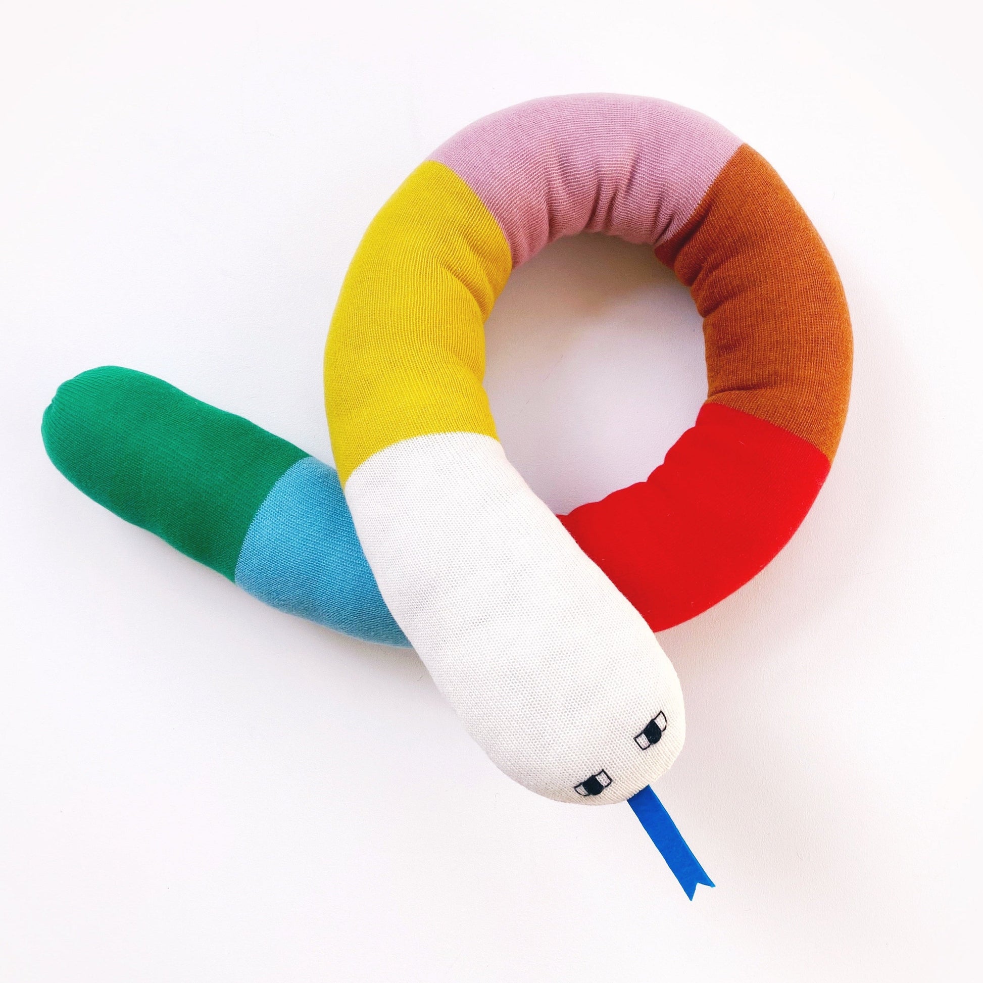 Colorful snake-shaped pillow on a white background