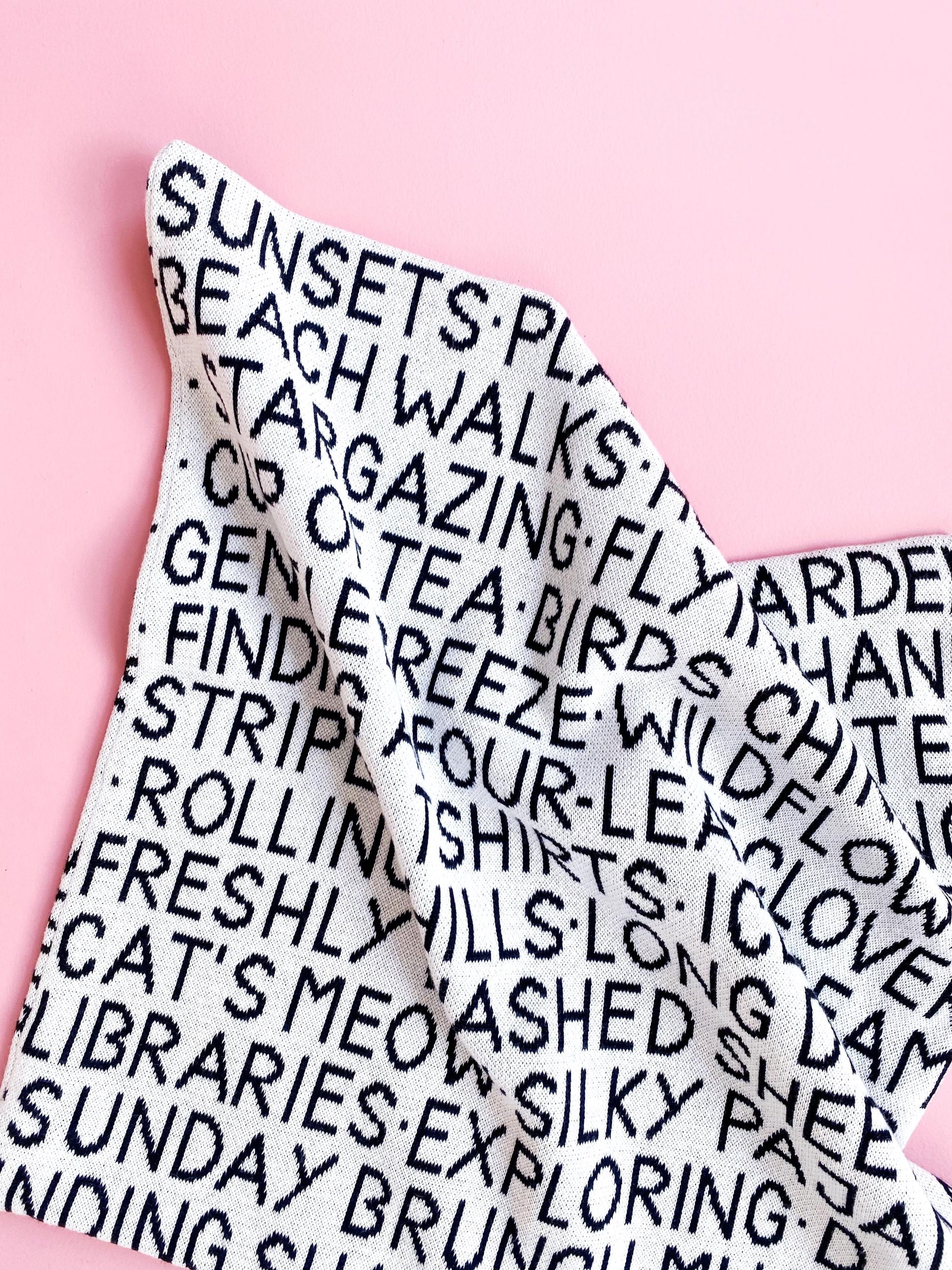 Textured fabric with printed text on a pink background