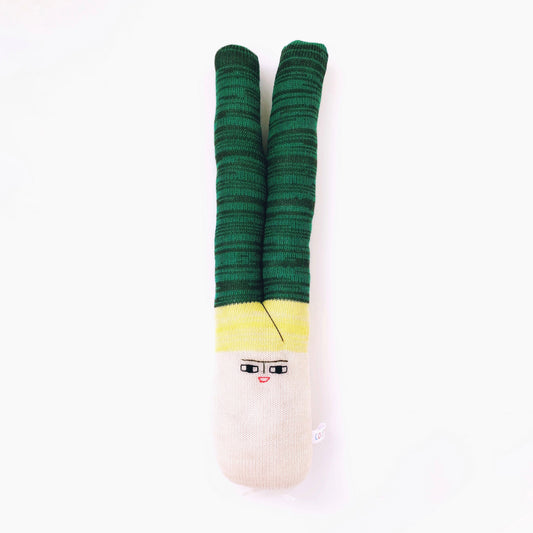 Green and yellow leek toy plush with a face design on a white background