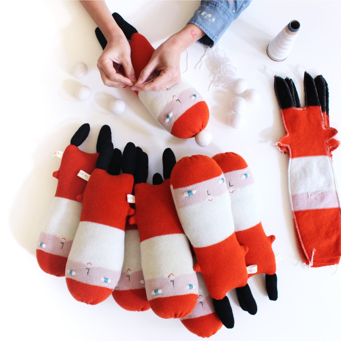 Red and white knitted Santa plush toys  on a white background