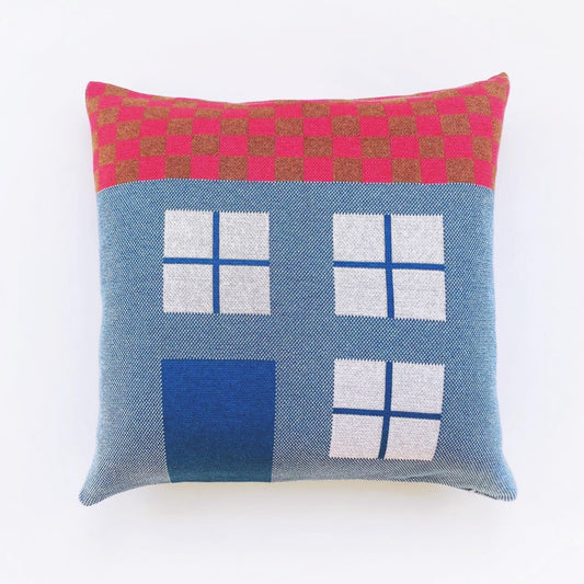 Decorative pillow with geometric house pattern on a white background