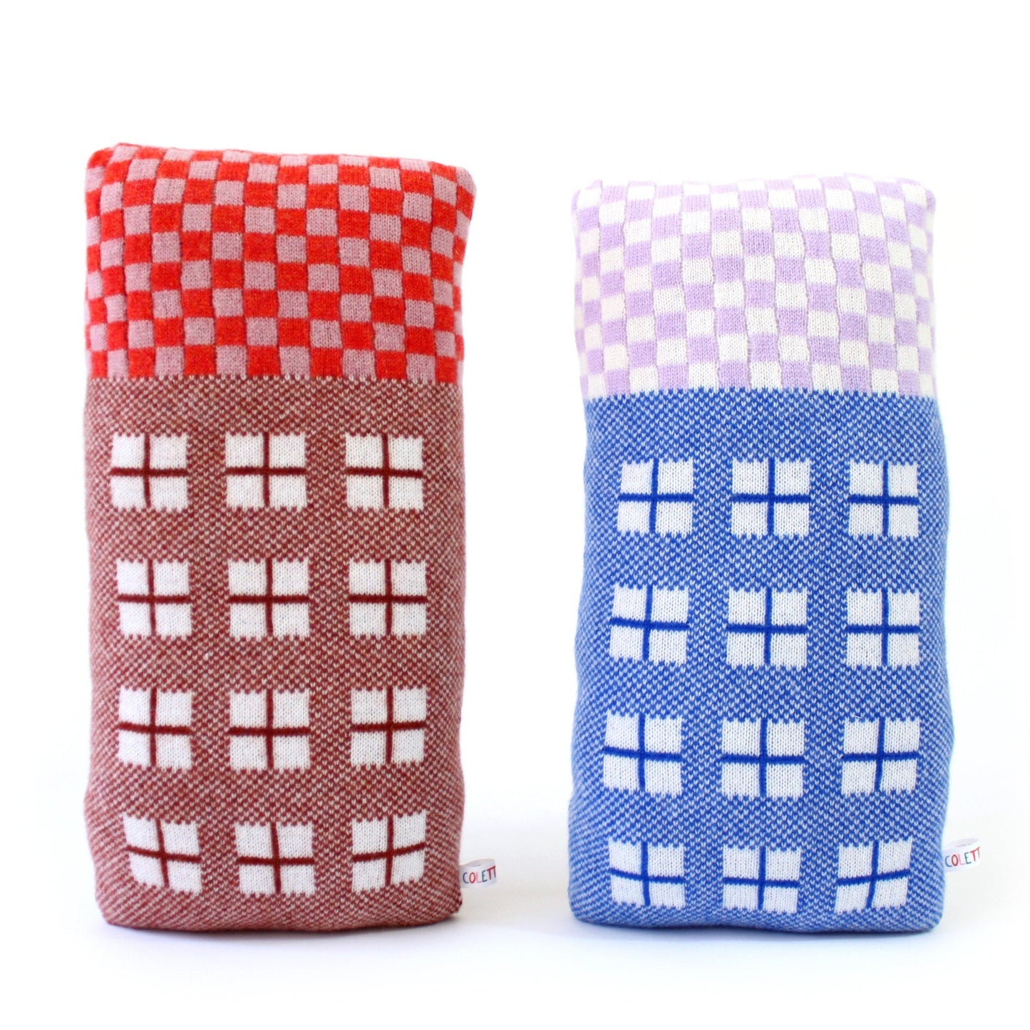 Two knitted house shaped pillows with checkered patterns on a white background
