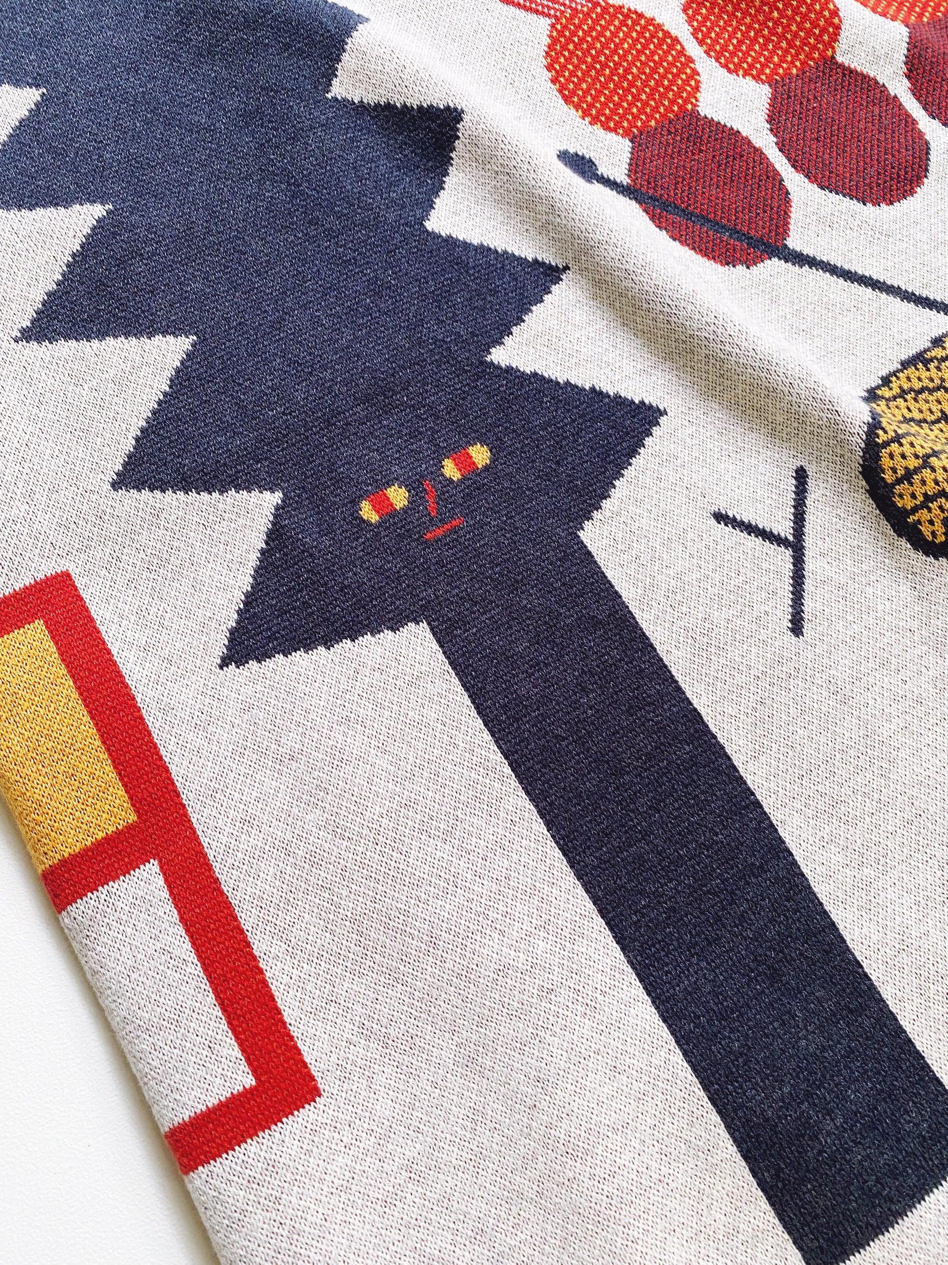 Close-up of a colorful knitted fabric with abstract patterns and shapes