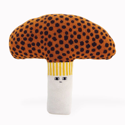 Toy mushroom knit pillow cushion with brown spotted cap and white stem on a white background
