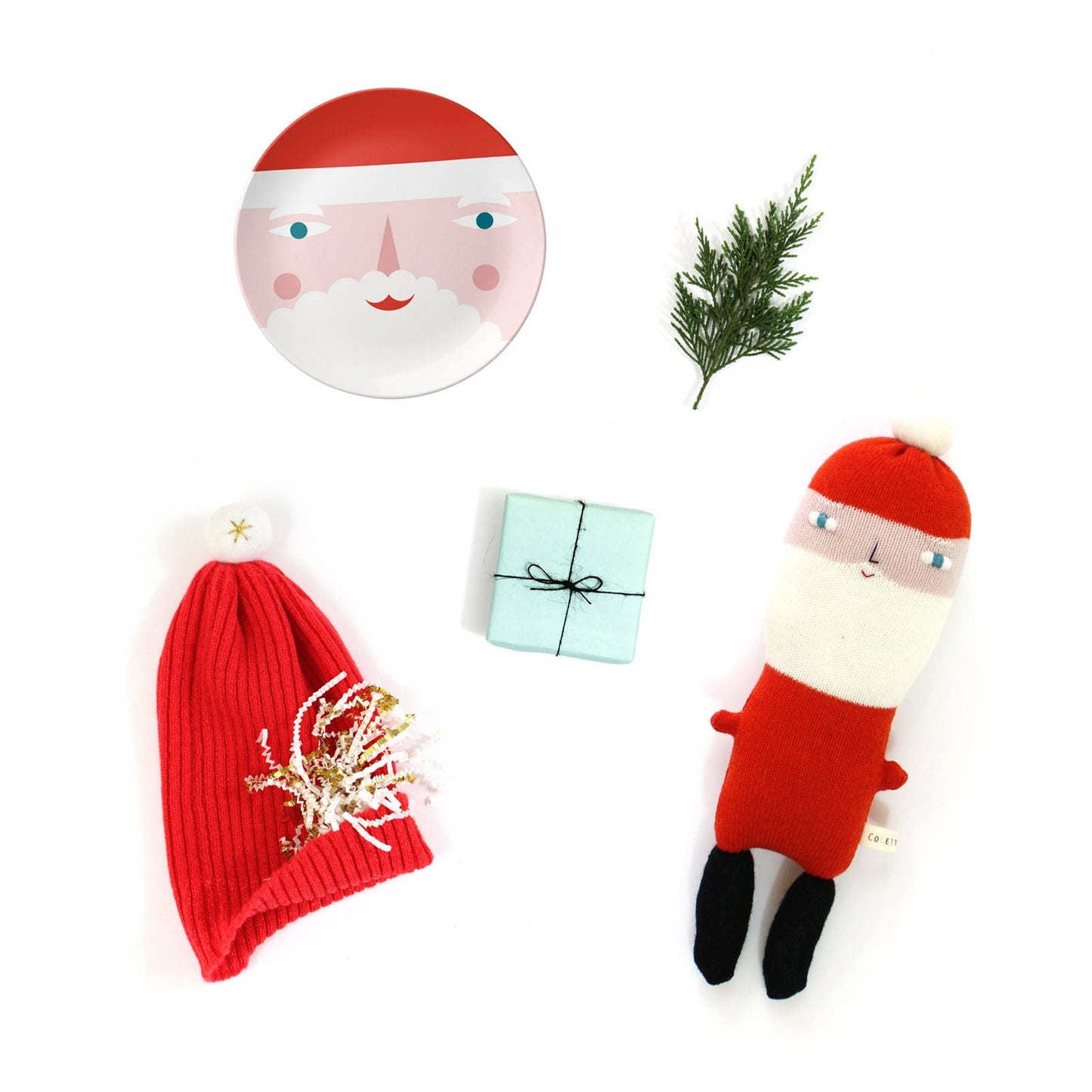 Collection of Christmas-themed items including a Santa hat, Santa plush toy, beanie, Santa face plate and gift box on a white background.