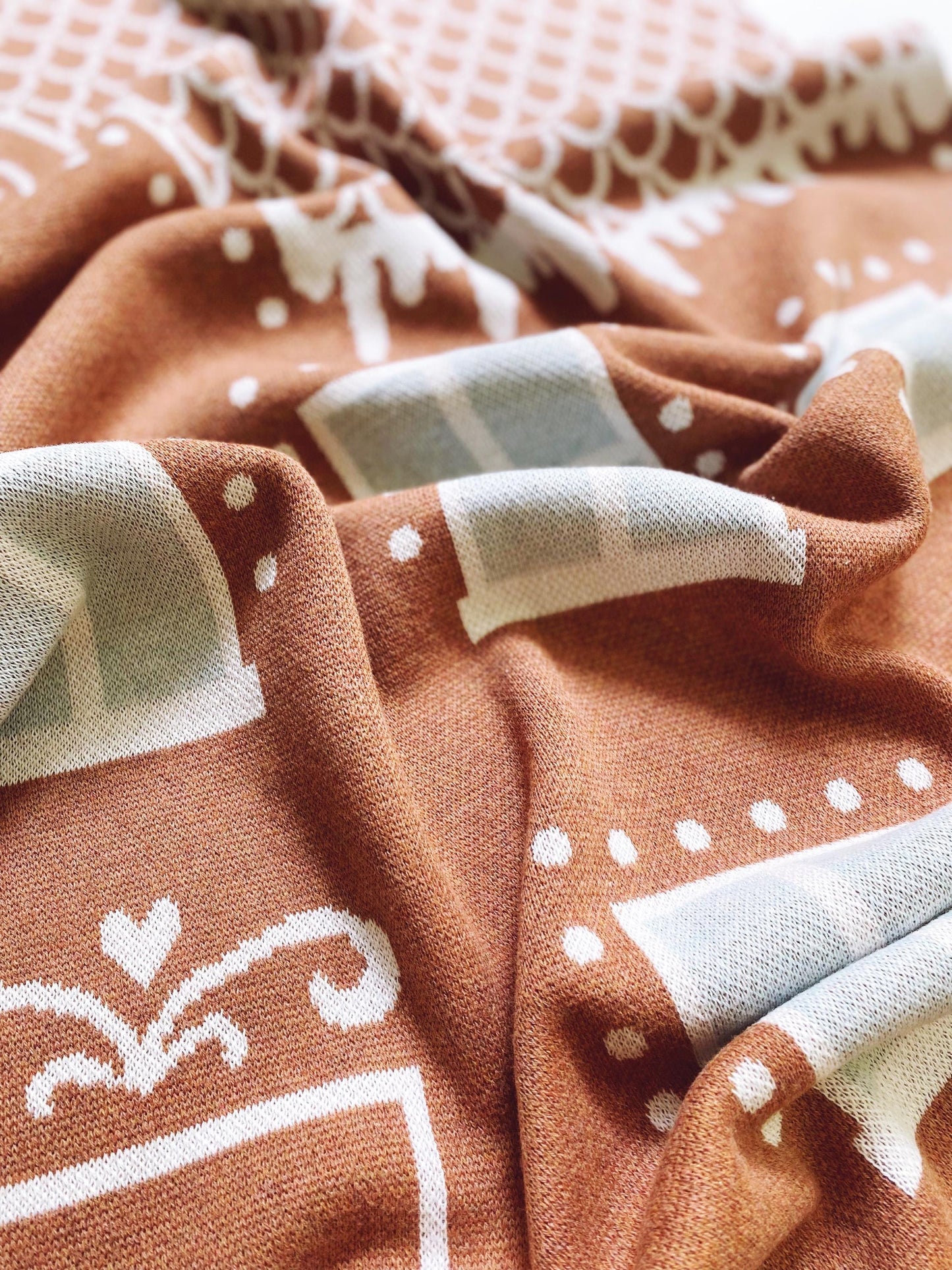 Close-up of brown knitted fabric with white patterns