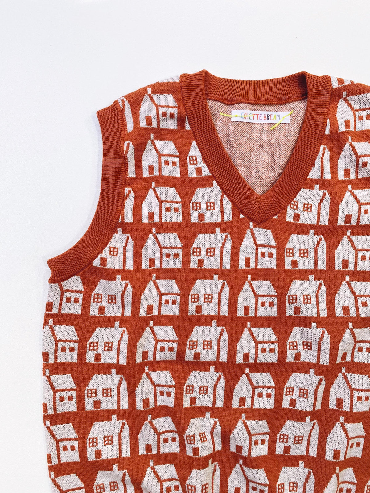 Knitted sleeveless sweater vest with house pattern on a white background