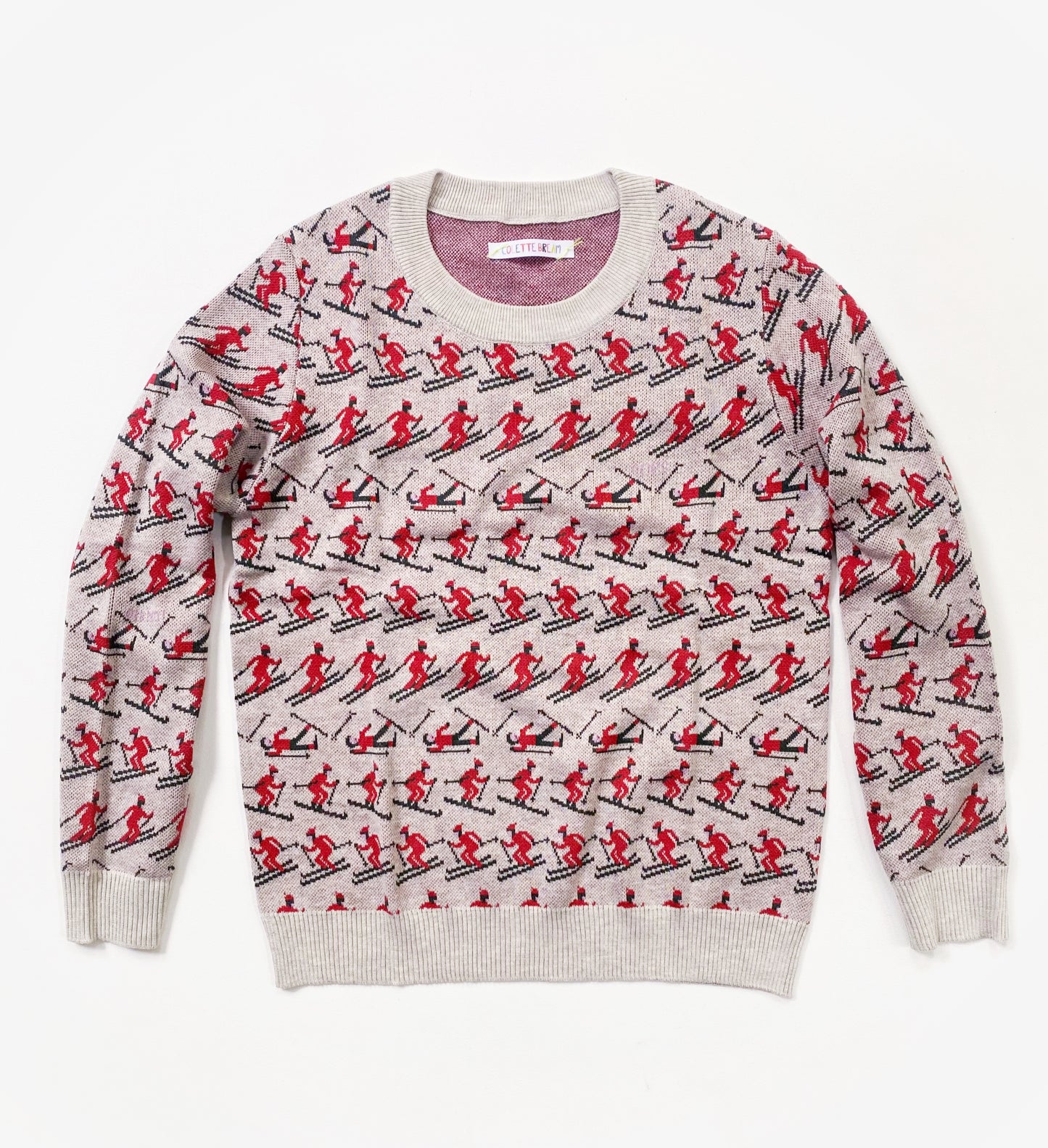 Sweater with red and black skier pattern on a white background