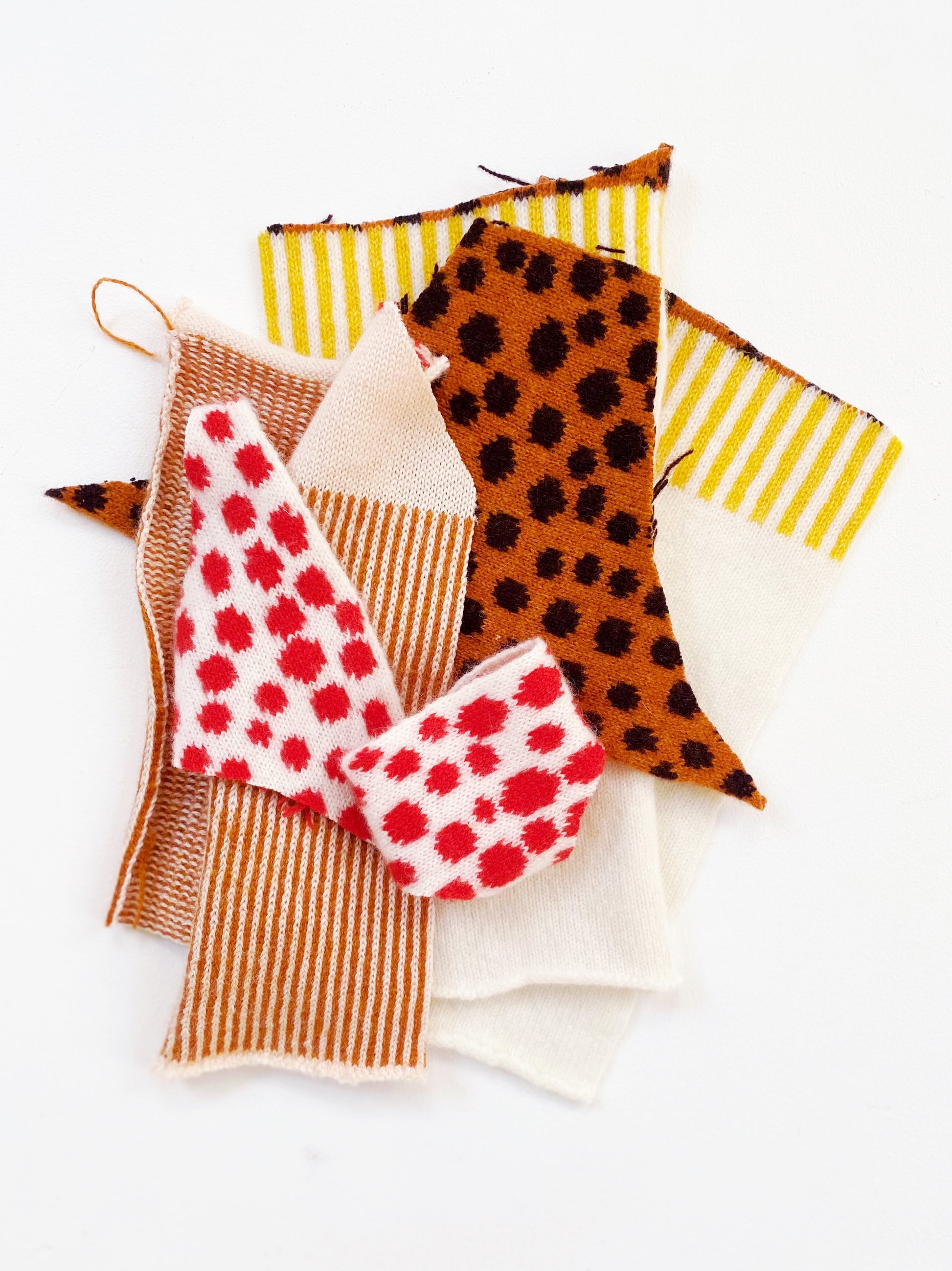 Set of colorful fabric samples with patterns on a white background