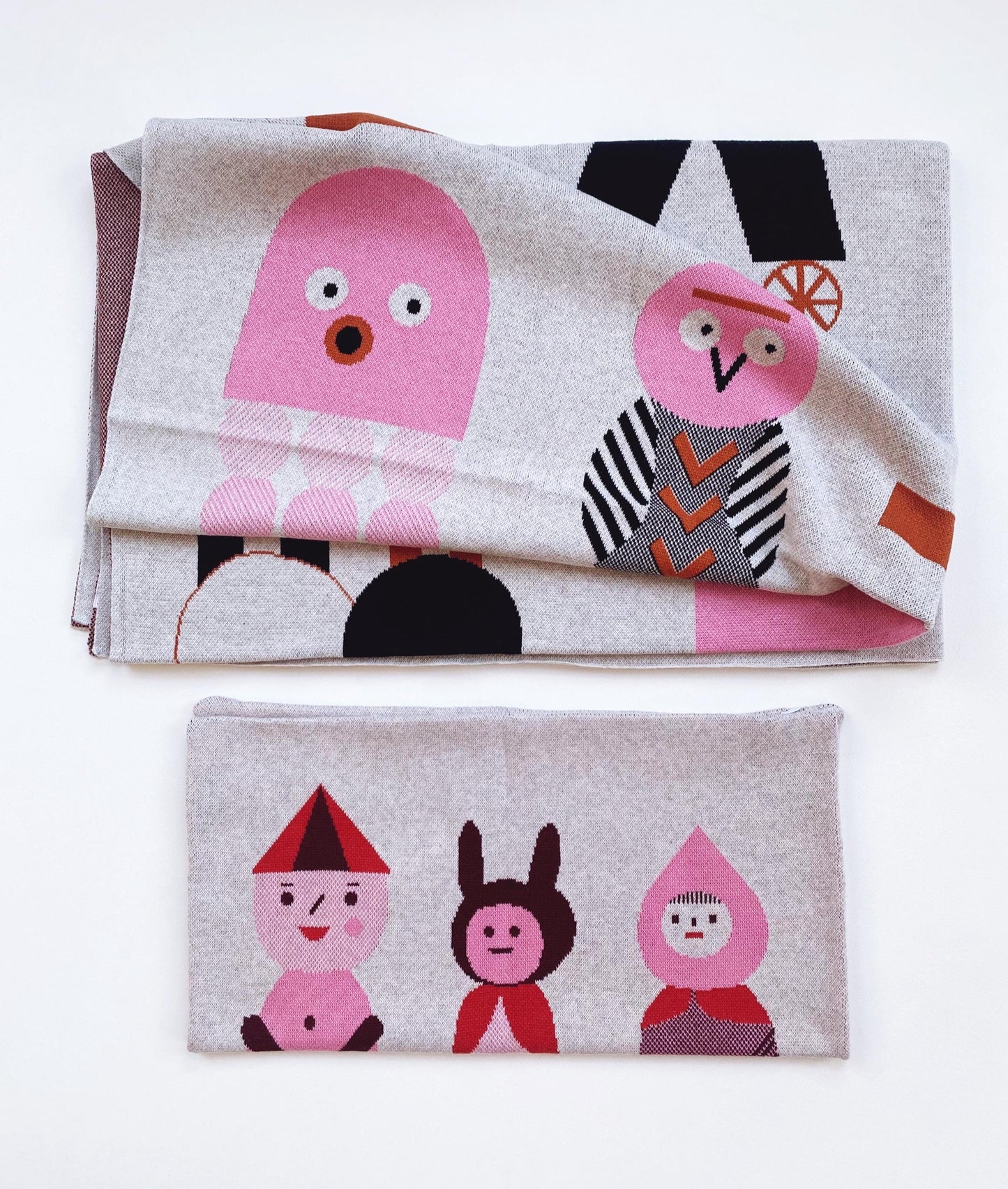 Two knitted fabric items with modern geometric cartoon character designs on a white background