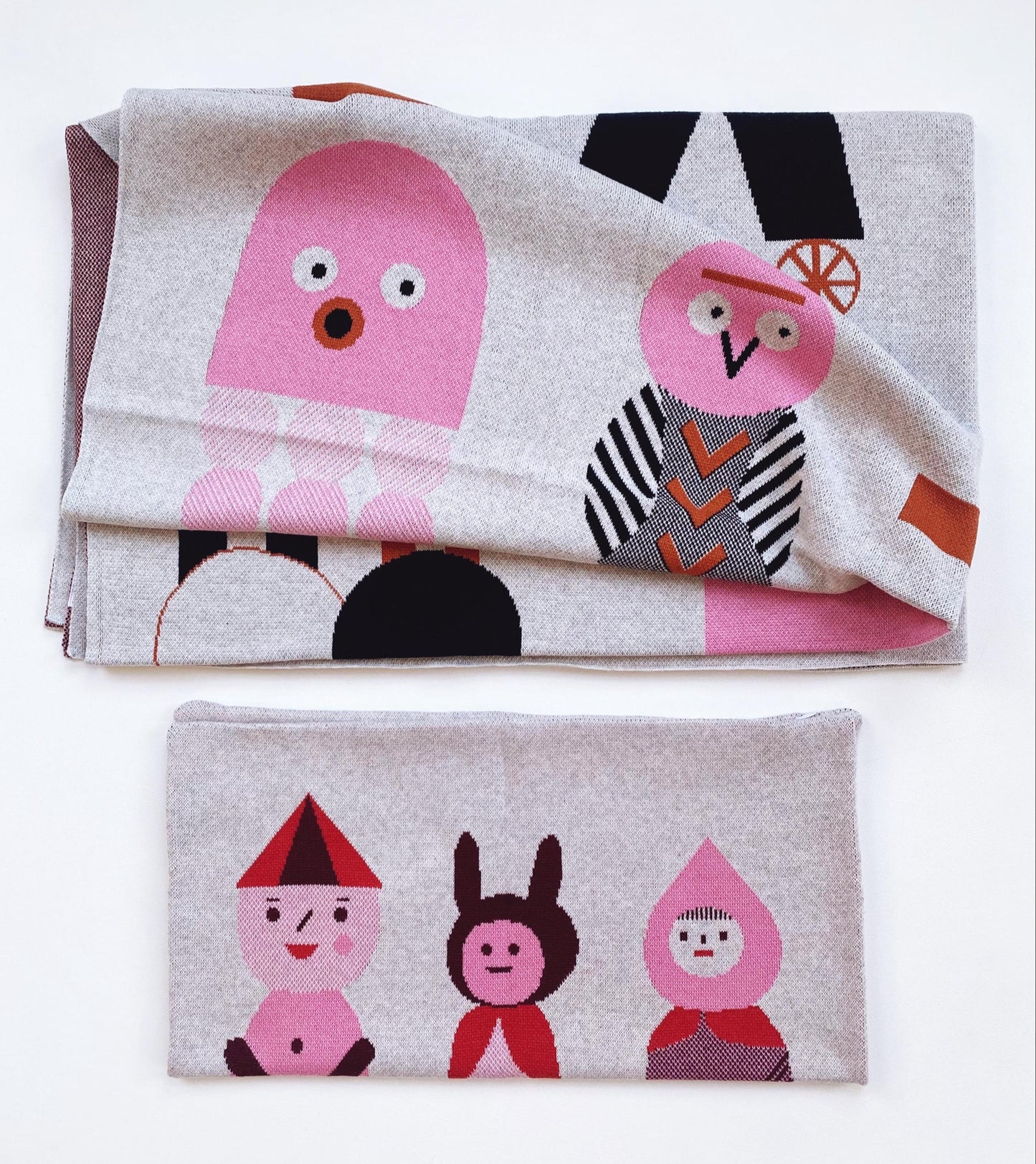 Two folded blankets with cartoon character designs on a white background