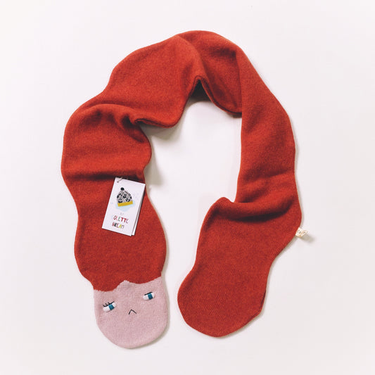 Red scarf with a pink face on a white background
