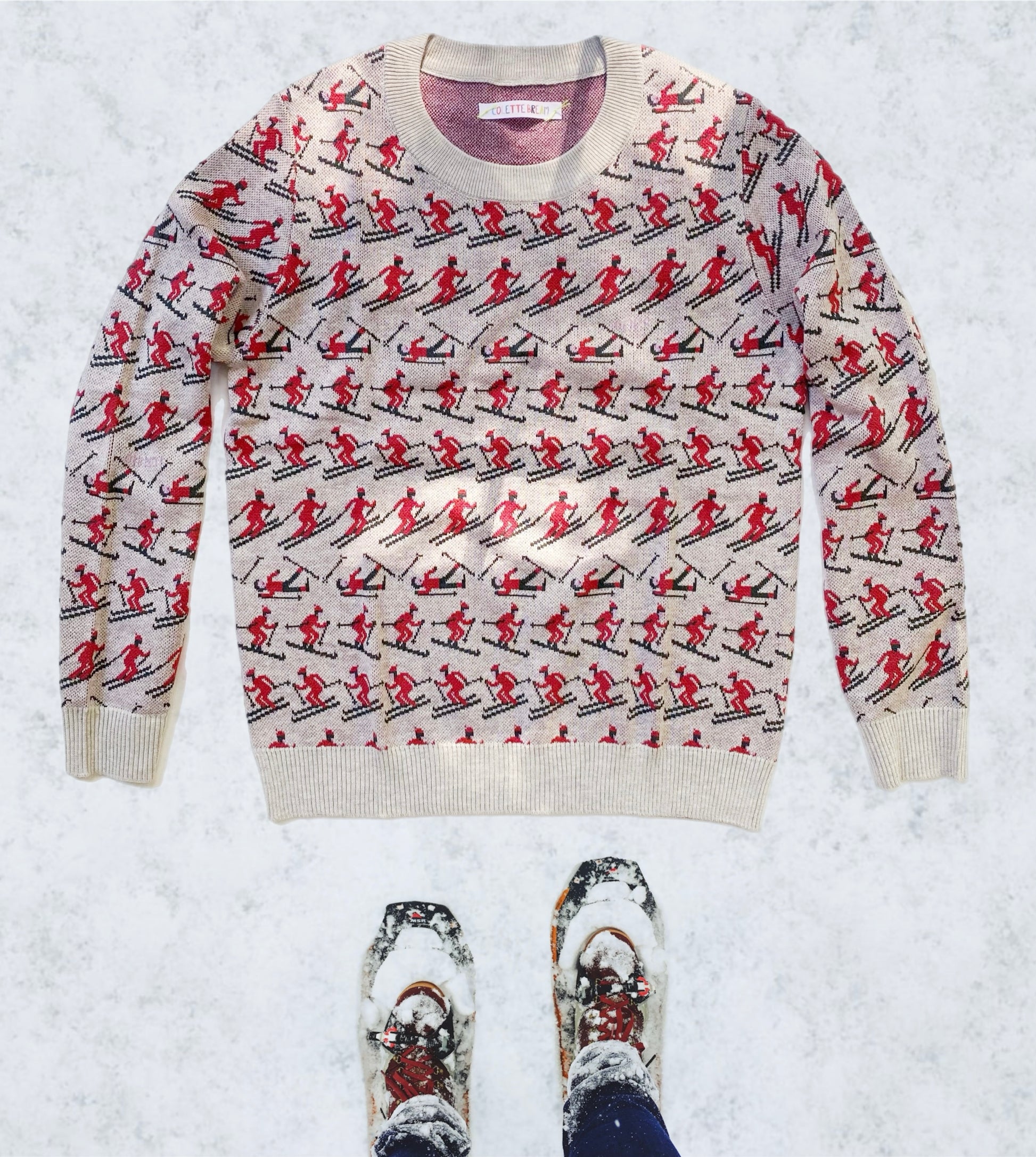 Sweater with skiing pattern on a snowy background