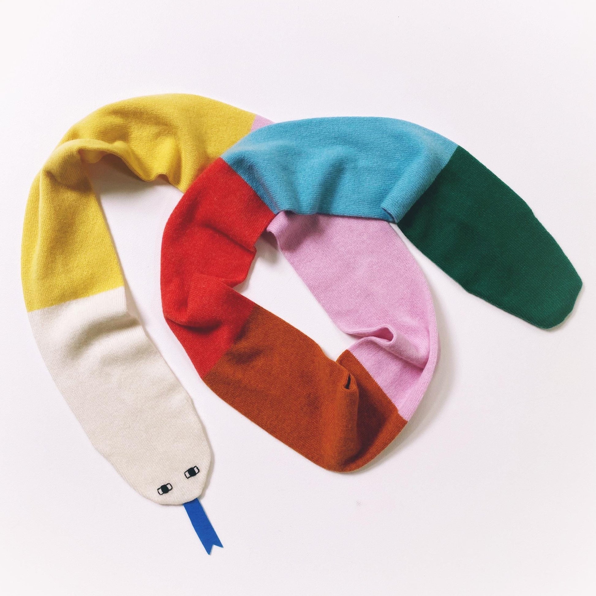 Colorful colorblocked snake scarf with gradient design on a white background