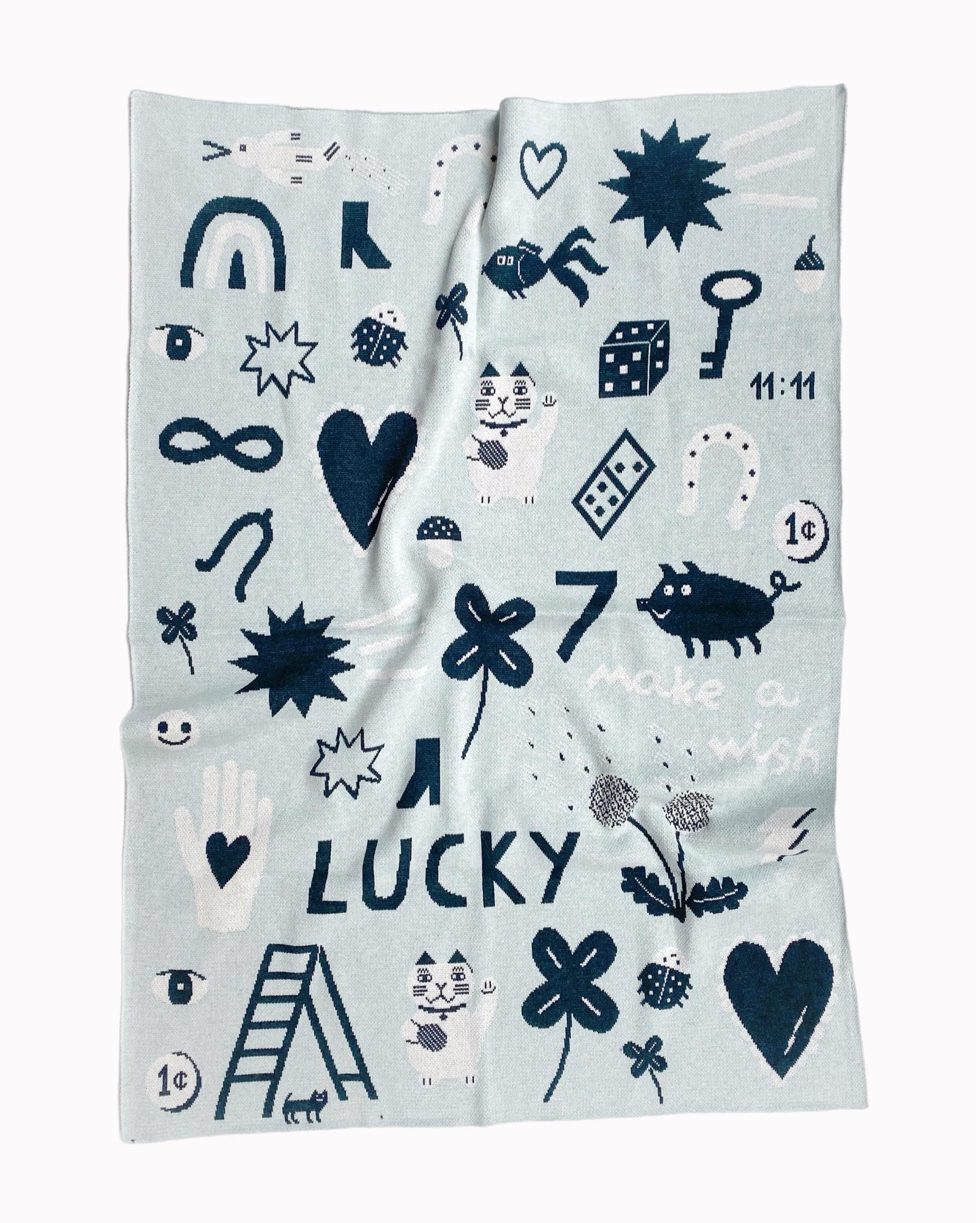 Knit blanket with blue lucky charms symbols pattern and text on a white background