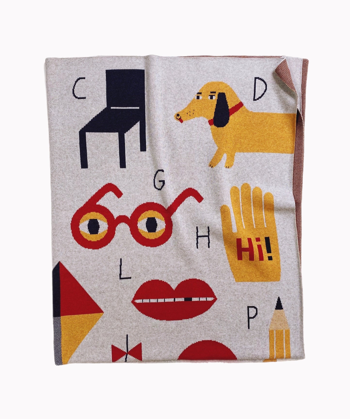 Knitted alphabet throw blanket with colorful graphics including a dog, glasses, and letters on a gray background